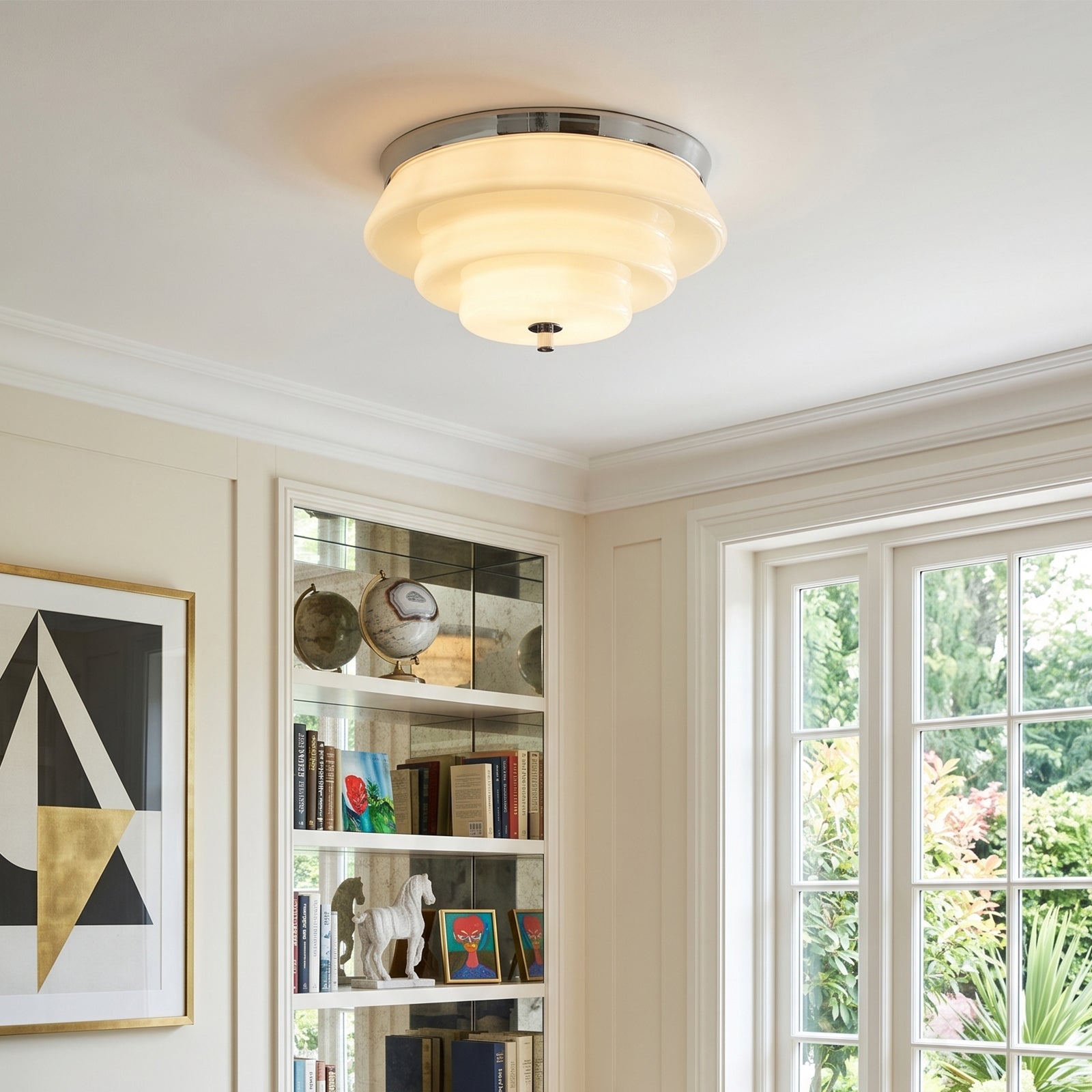 Stylish Statement Ceiling Lights illuminating a modern room with elegant decor and bookshelves.