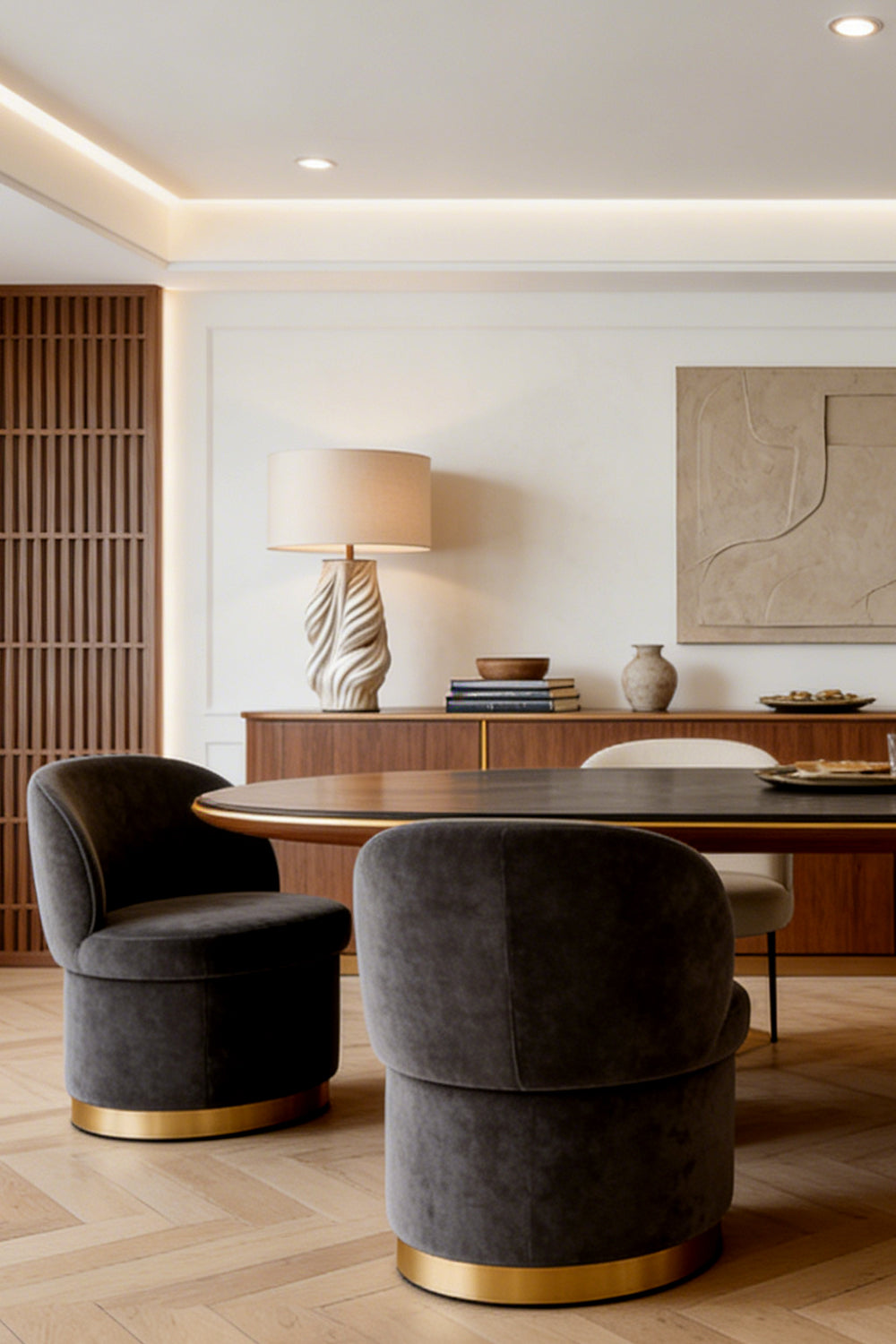 Adara Sculptural Ceramic Table Lamp | Ceramic, Fabric | Staged elegantly on a long wooden credenza sideboard in a refined open-plan dining and living space with dark accents | Samu Lamp