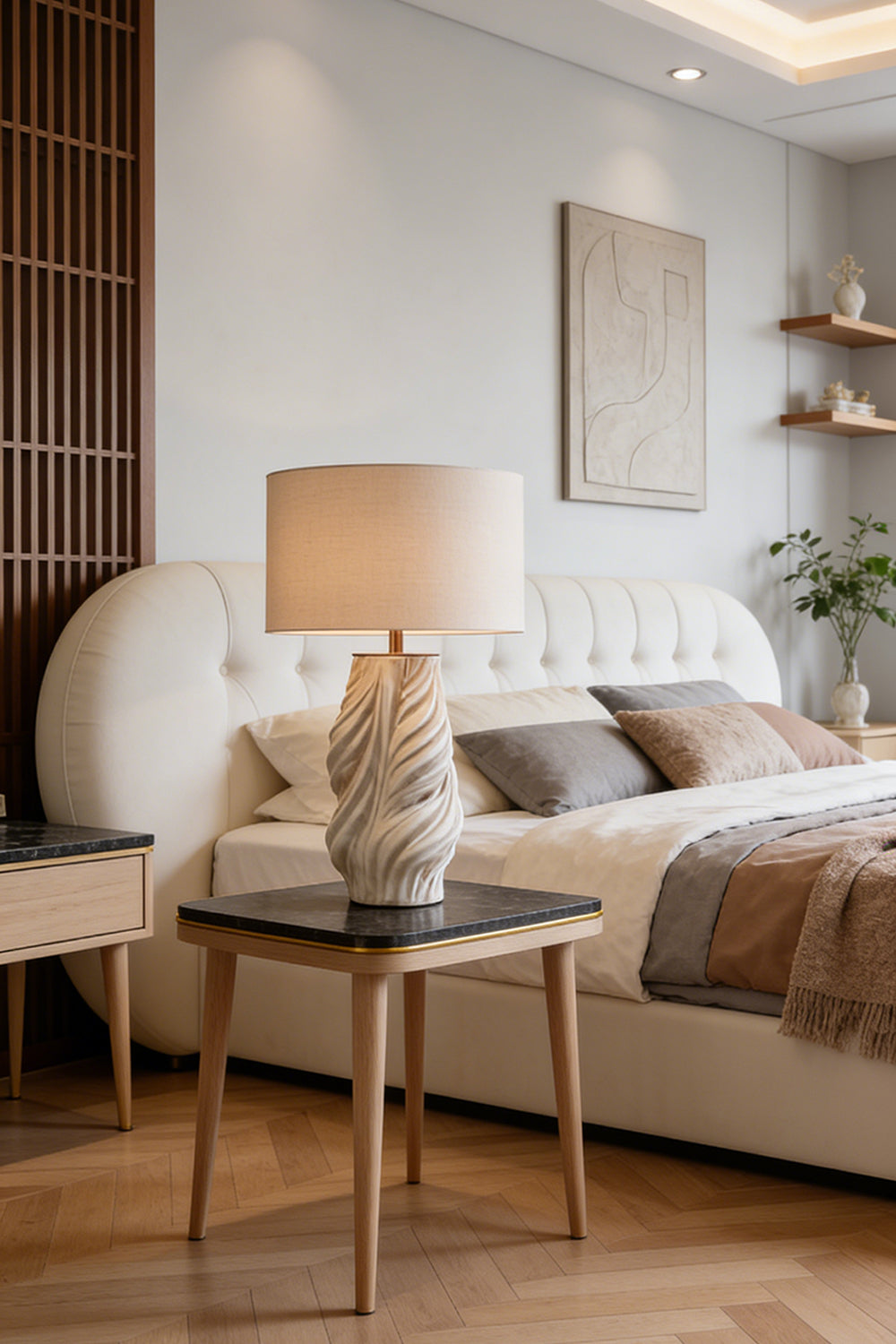 Adara Sculptural Ceramic Table Lamp | Ceramic, Fabric | Serving as a cozy bedside lamp on a wood nightstand next to a contemporary platform bed with neutral linens | Samu Lamp