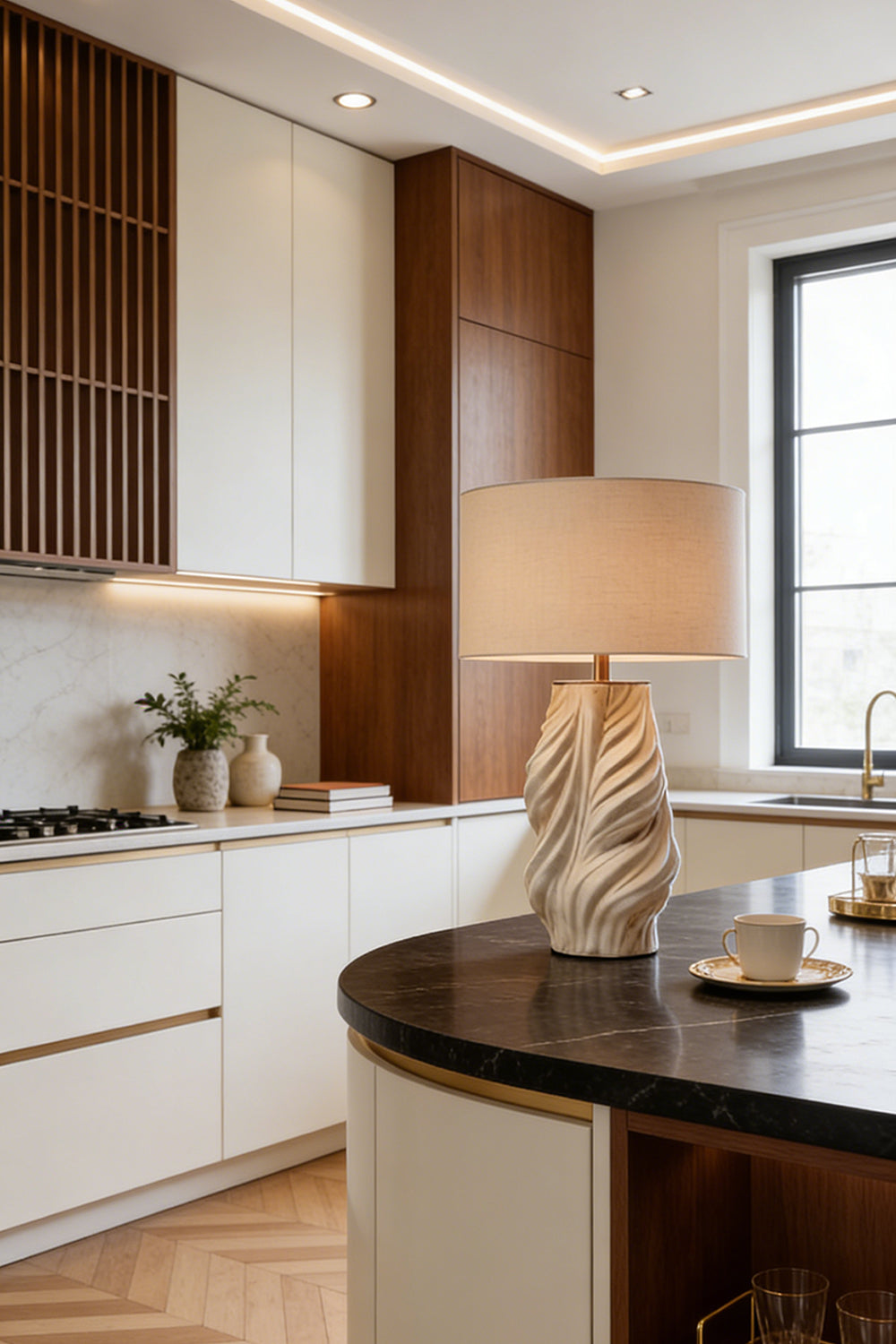 Adara Sculptural Ceramic Table Lamp | Ceramic, Fabric | Placed on a modern curved kitchen island countertop, casting a soft ambient glow next to minimalist wood cabinetry | Samu Lamp