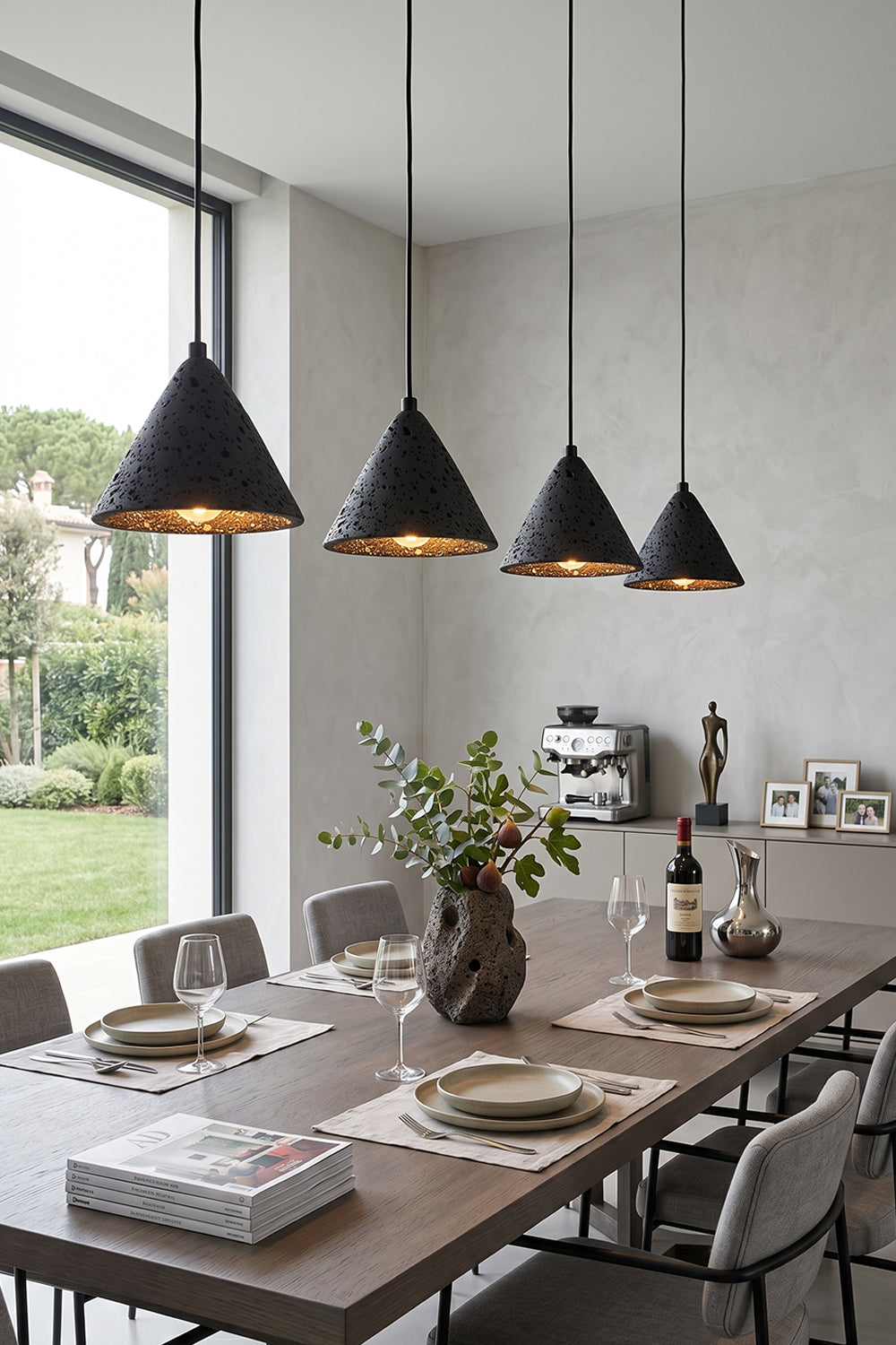 Linear arrangement of Aethel Core Pendants | Black Travertine, Metal | Modern dining room with long wooden table | Samu Lamp