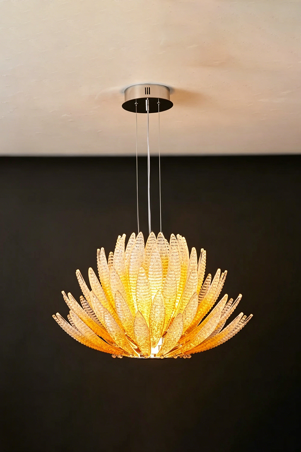 Helios Agave Glass Starburst Chandelier | Glass, Metal | Amber glass variant unlit against a black background, displaying the natural amber tint | Isolated shot | Samu Lamp
