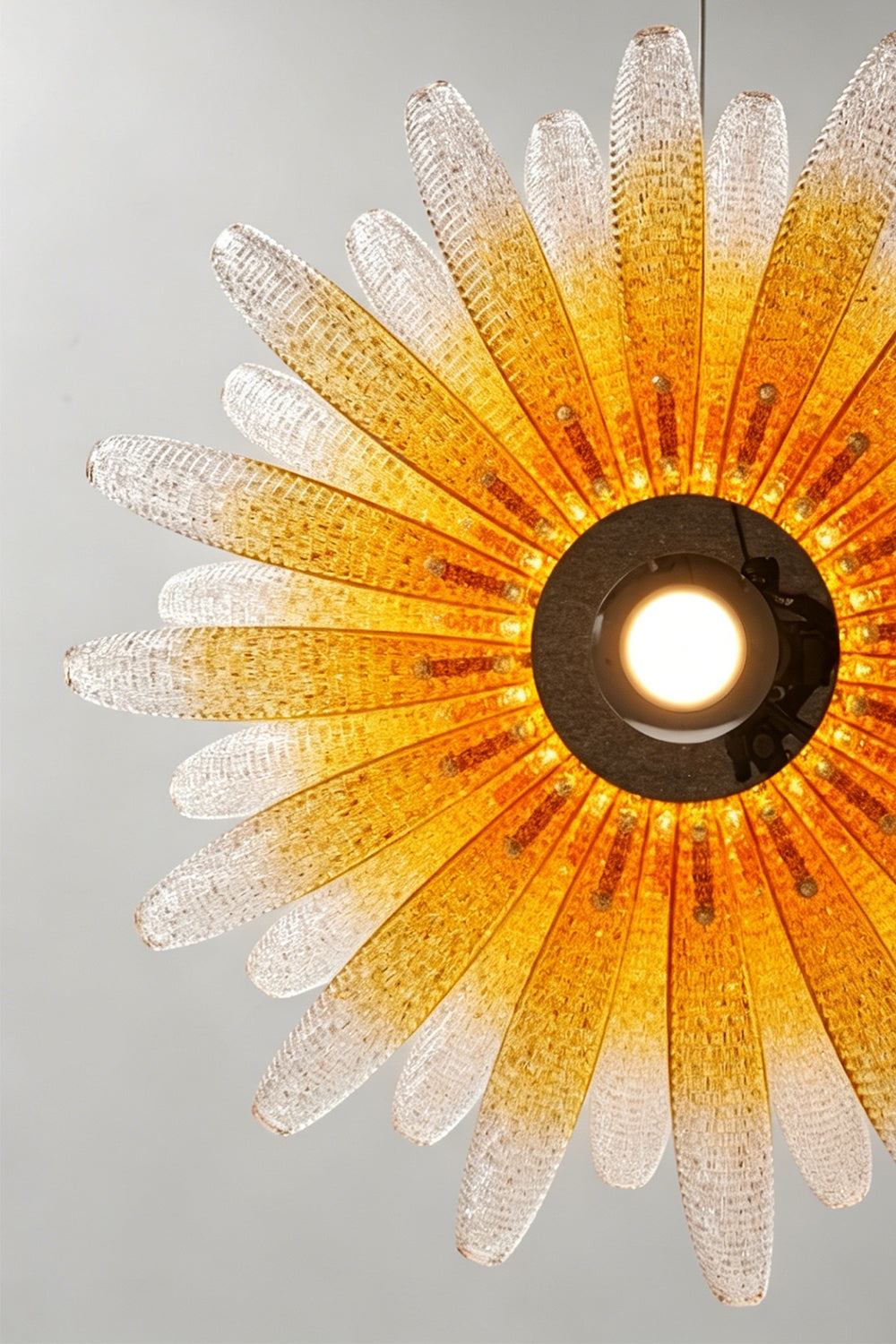 Helios Agave Glass Starburst Chandelier | Glass, Metal | Looking directly up at the fully lit chandelier, showing the warm amber gradient spreading from the center | Detail shot | Samu Lamp