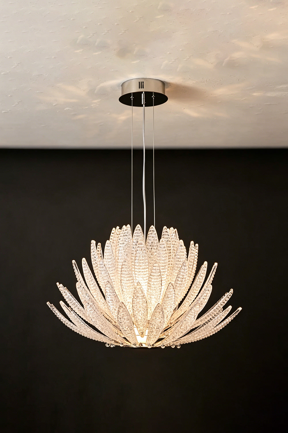 Helios Agave Glass Starburst Chandelier | Glass, Metal | Clear glass variant unlit against a black background, showing the frosty glass texture | Isolated shot | Samu Lamp