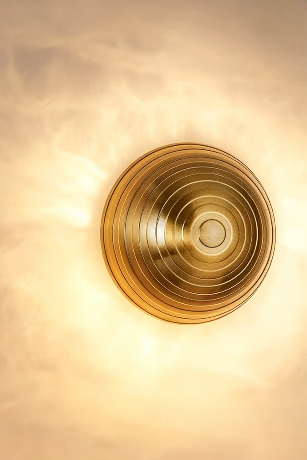 Backlit alabaster wall light detail | Brass | Alabaster | Close-up showing natural stone grain and warm illumination | Samu Lamp