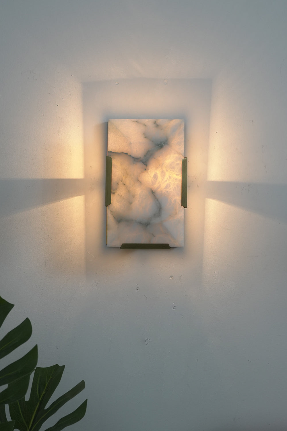 Lit 1-panel rectangular alabaster wall lamp with brass accents | Brass, Alabaster | Front view isolated on white background | Samu Lamp