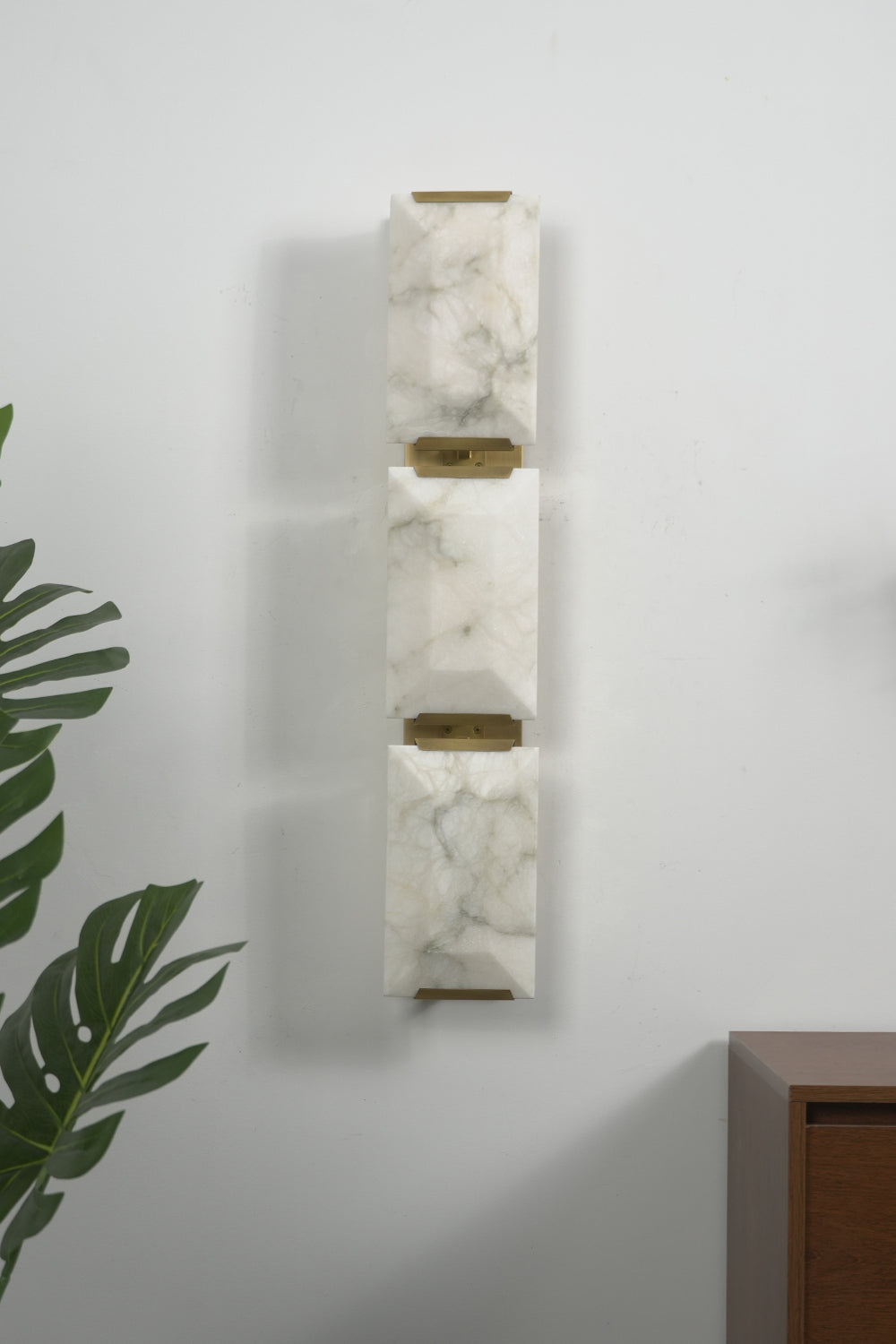 Lit 3-panel rectangular alabaster wall lamp with brass accents | Brass, Alabaster | Front view isolated on white background | Samu Lamp
