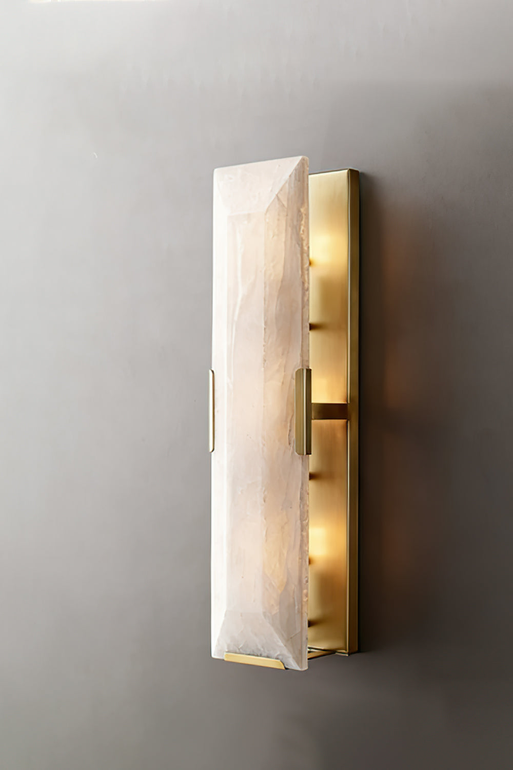 Lit rectangular alabaster wall sconce | Brass, Alabaster | Front view against a neutral background | Samu Lamp