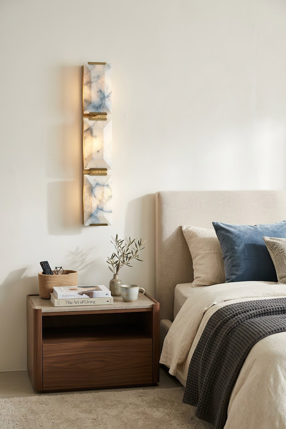 Vertical 3-panel alabaster wall sconce | Brass, Alabaster | Installed in a bedroom above a wooden nightstand | Samu Lamp