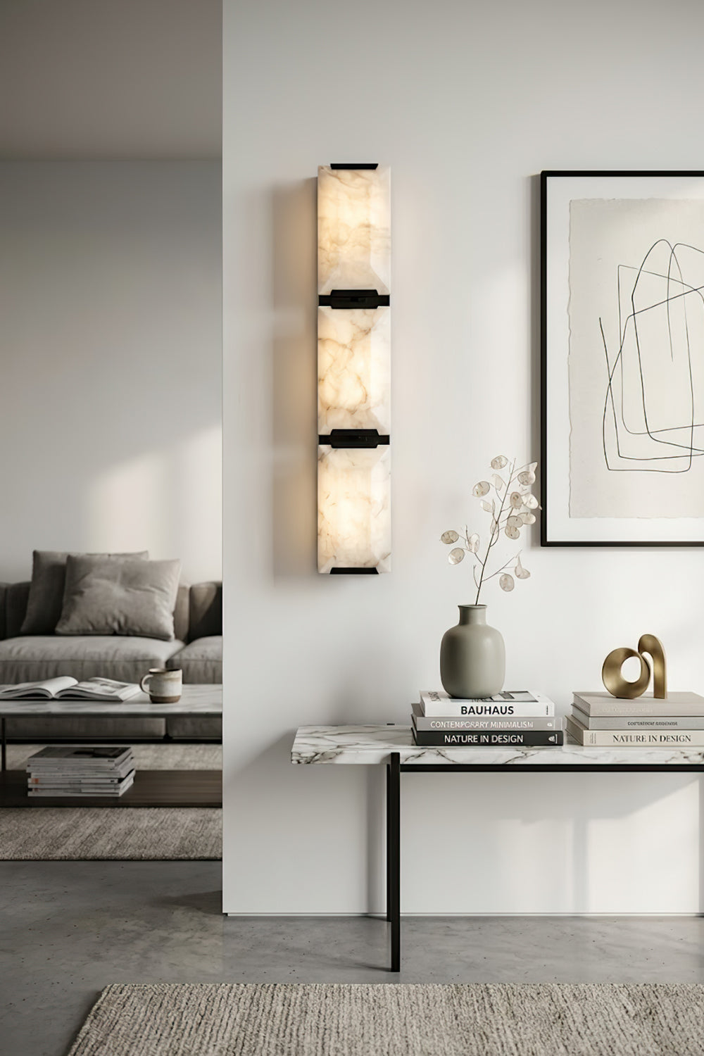 Vertical 3-panel alabaster wall lamp | Brass, Alabaster | Installed in a high-ceiling gallery room with a console | Samu Lamp