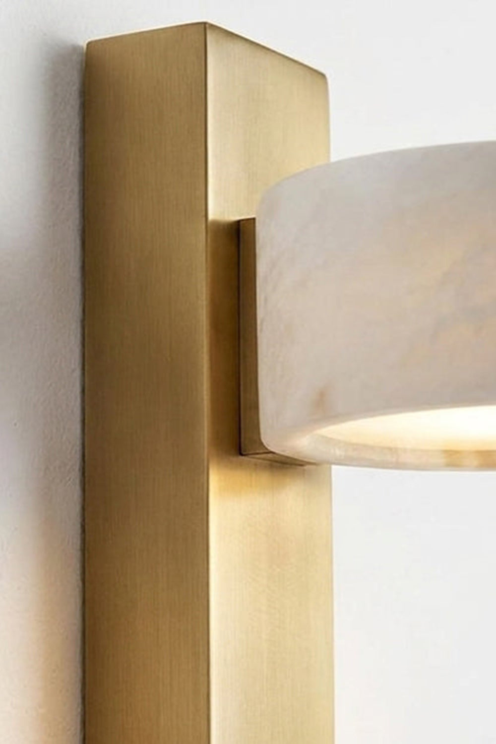 Alaric Alabaster Bar Wall Sconce | Natural Alabaster and Brass | Side perspective close-up view showcasing the thickness of the vertical brass rectangular bar and stone attachment | Samu Lamp