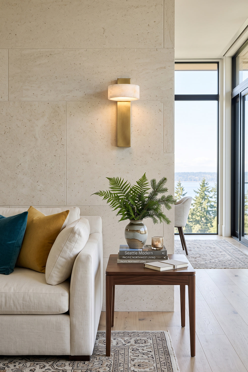 Alaric Alabaster Bar Wall Sconce | Natural Alabaster and Brass | Styled on a textured stone wall behind a cream sofa and a wooden console table with a green plant | Samu Lamp