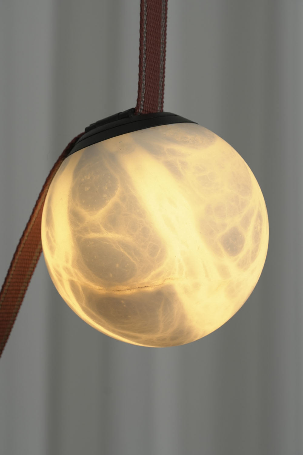 Albiane Draped Chandelier | Translucent Alabaster | Macro lit close-up of stone globe showing warm veining | Samu Lamp