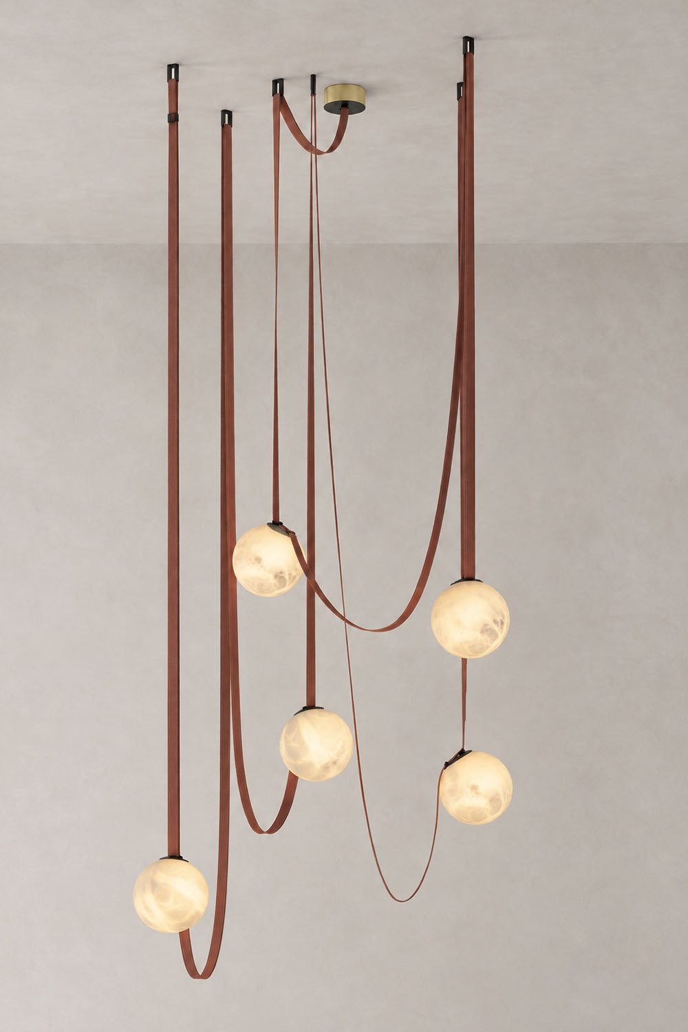Albiane Draped Chandelier | Alabaster and Woven Rope | Staggered 5-globe cluster illuminated against wall | Samu Lamp