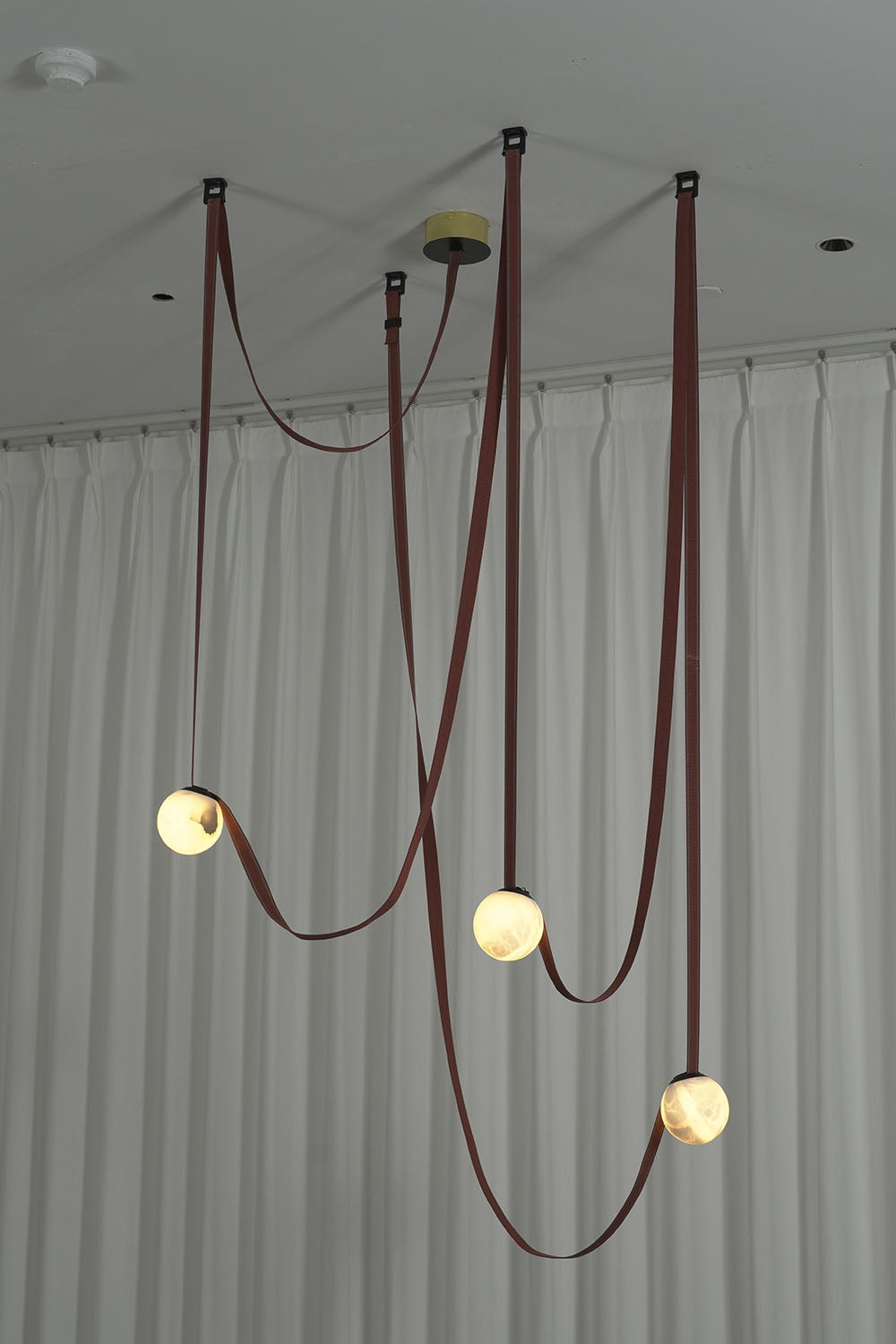 Albiane Draped Chandelier | Alabaster and Woven Rope | Cascading globes and red rope draped on white curtain | Samu Lamp