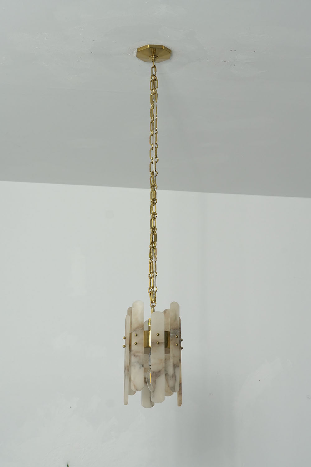 Albrenne Alabaster Mini Pendant | Natural Stone and Brass | Full hanging length shown against clean white wall | Samu Lamp