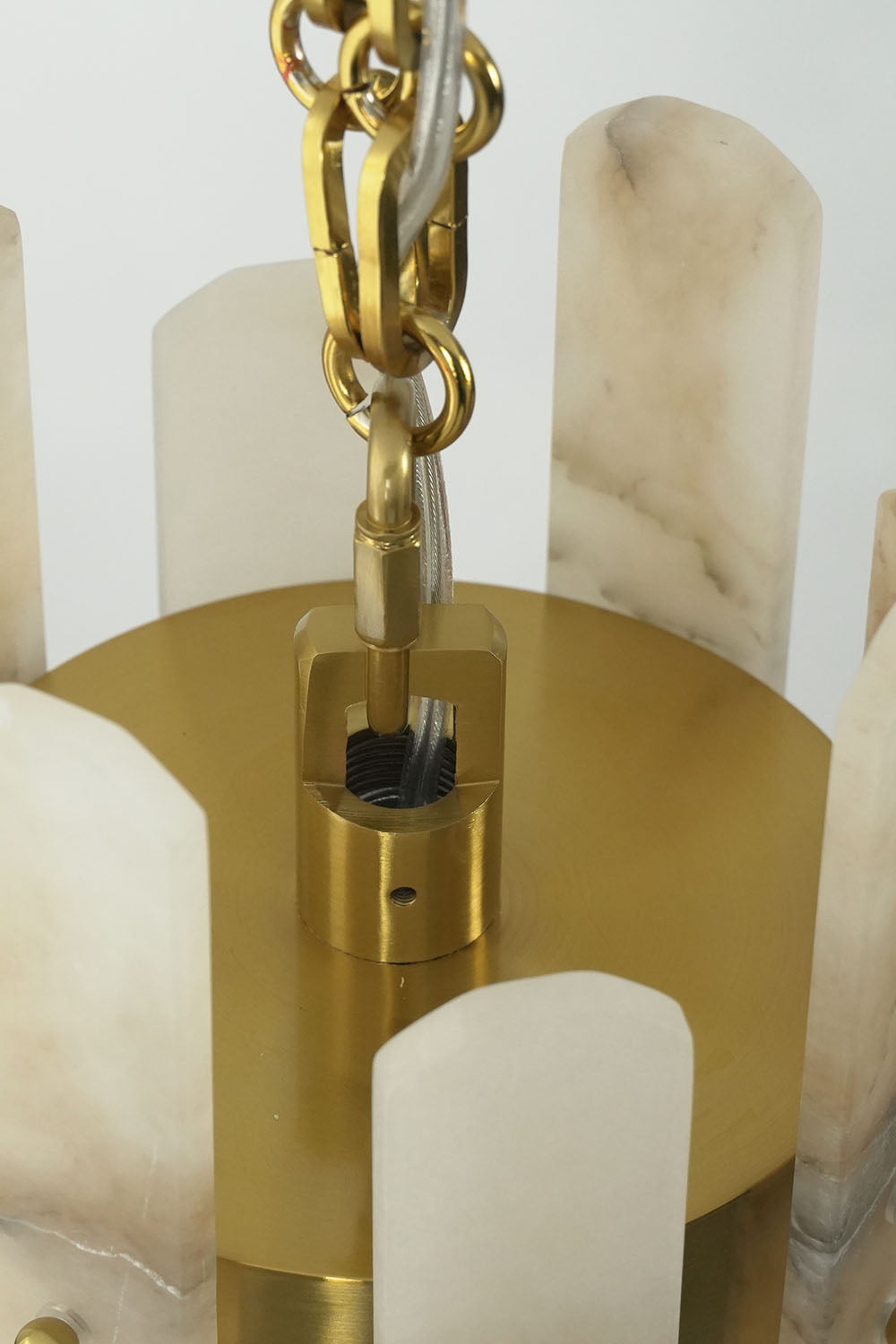 Albrenne Alabaster Mini Pendant | Solid Brass and Alabaster | Top close-up view of circular brass plate and chain | Samu Lamp