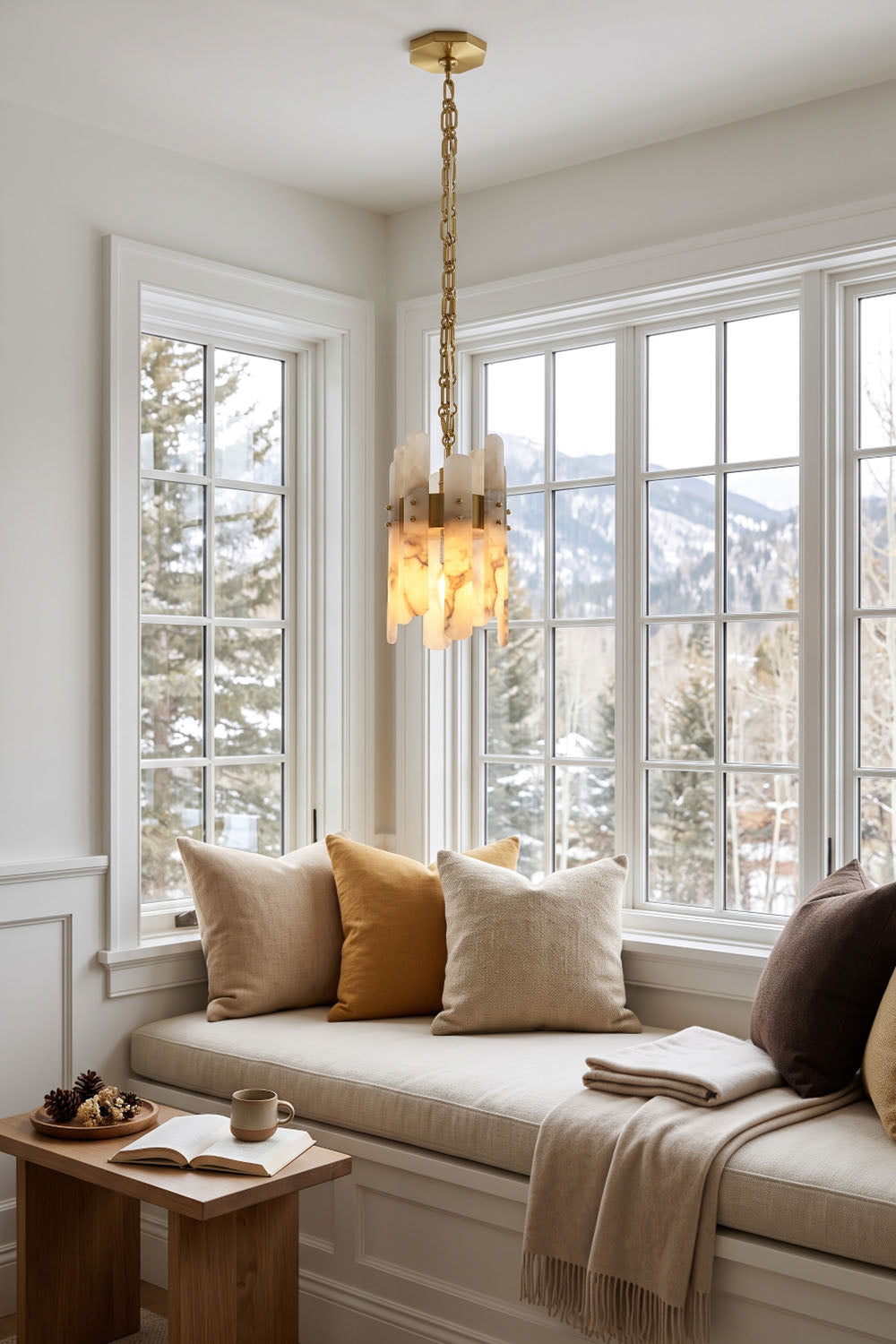 Albrenne Alabaster Mini Pendant | Natural Stone and Brass | Suspended above a cozy window reading bench nook | Samu Lamp
