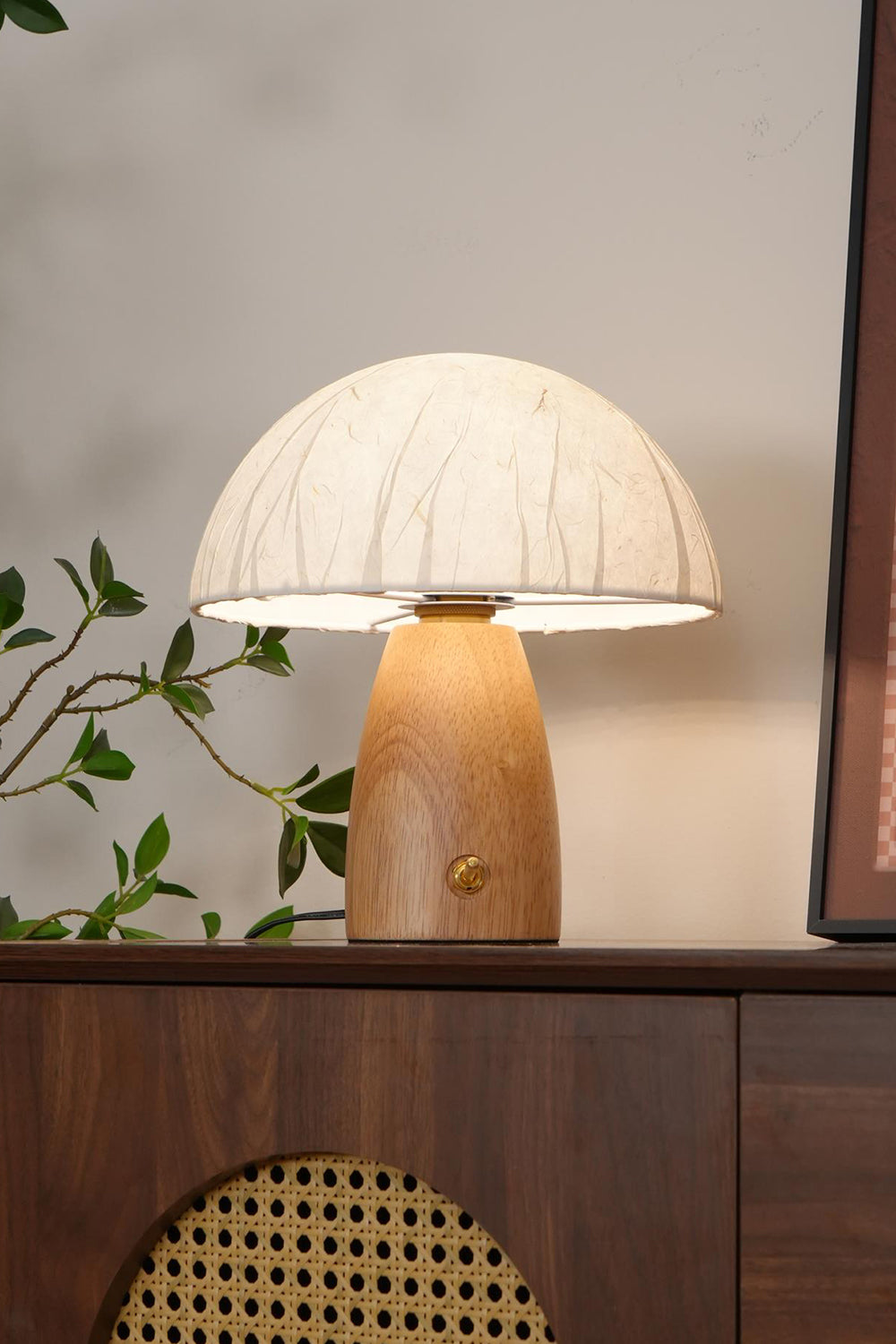 Alice Mushroom Table Lamp | Wood, Glass | Positioned on a dark wood sideboard cabinet with rattan panels, creating a warm mid-century modern vibe | Samu Lamp