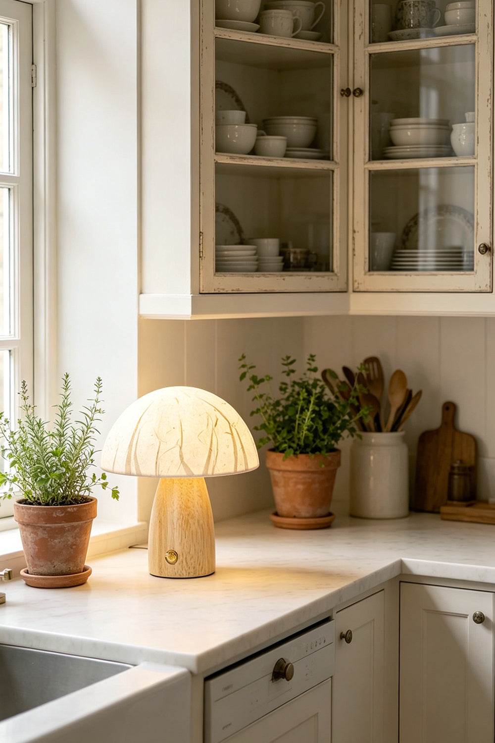 Alice Mushroom Table Lamp | Wood, Glass | Set on a clean white kitchen countertop next to a window with potted green herbs and classic cabinets | Samu Lamp