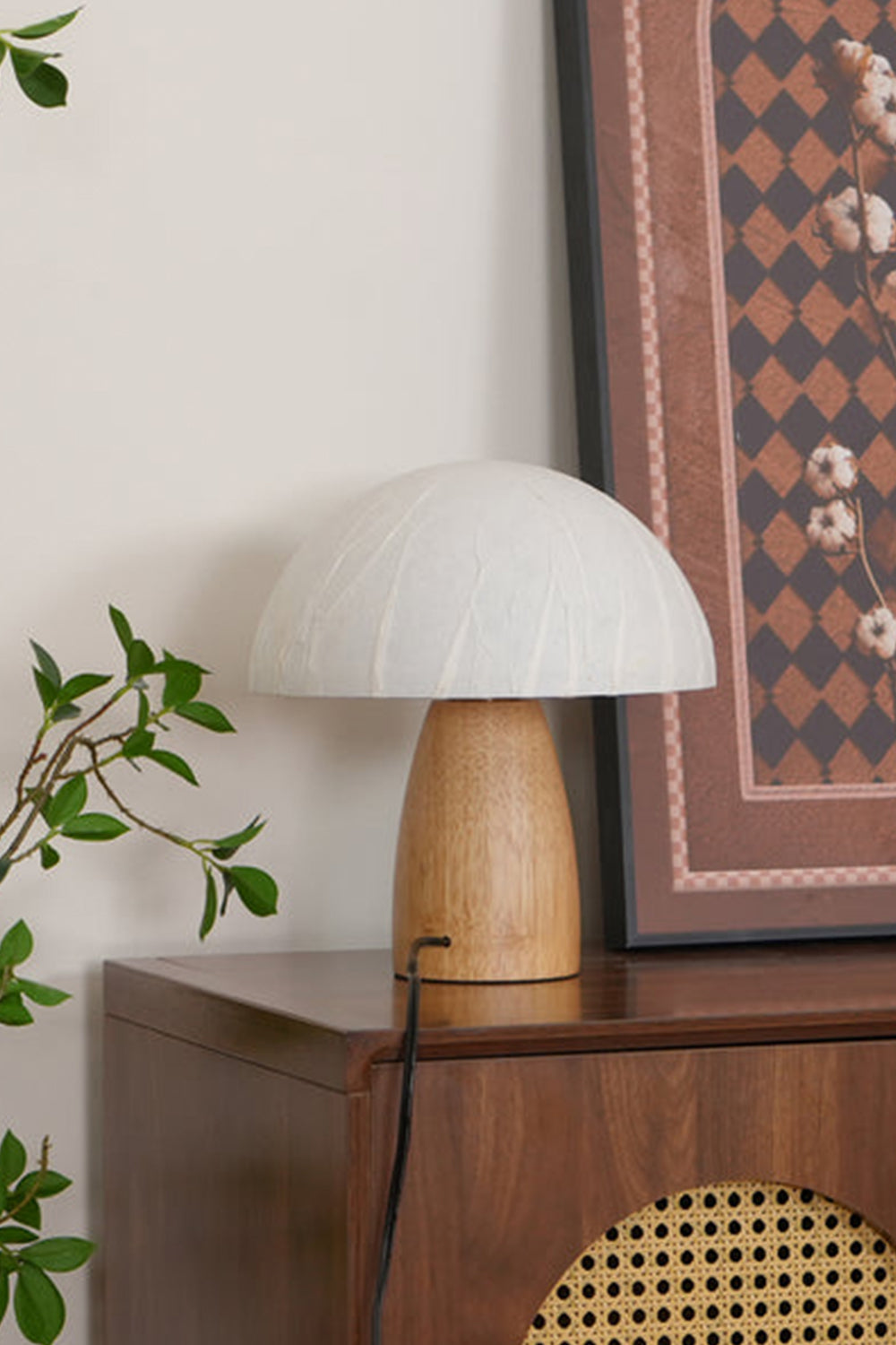 Alice Mushroom Table Lamp | Wood, Glass | Placed on a retro wooden cabinet with a framed geometric art print resting against the wall | Samu Lamp