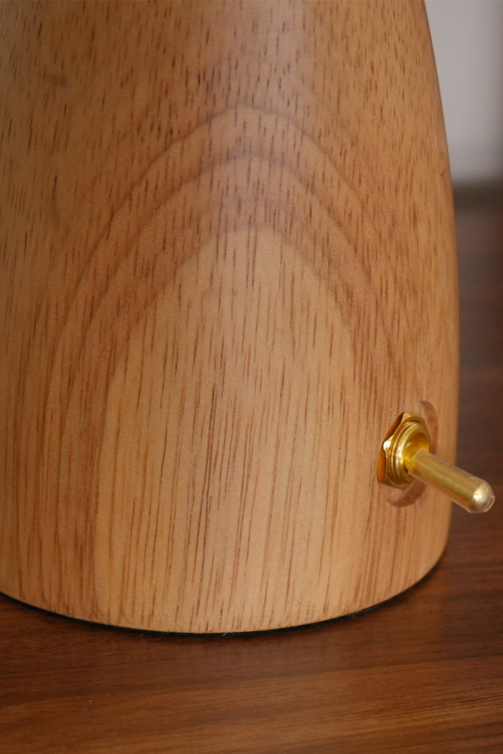 Alice Mushroom Table Lamp | Wood, Glass | Detailed macro shot of the smooth natural oak wood tapered base featuring a small gold metal toggle switch | Detail shot | Samu Lamp