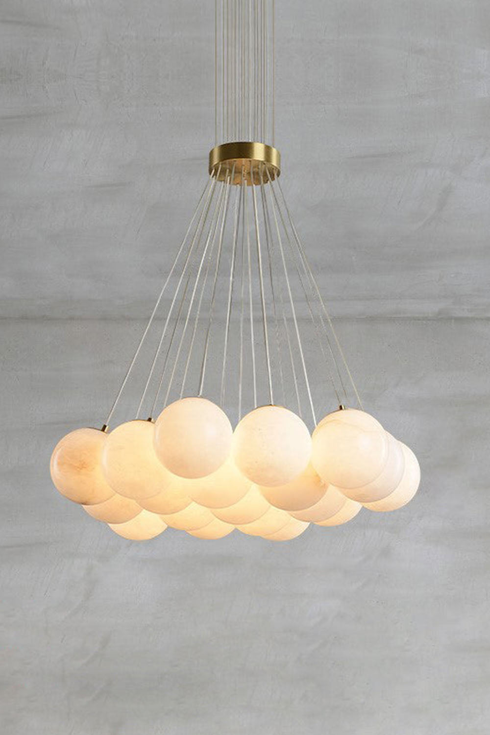 Amandine Alabaster Globe Cluster Pendant Light hanging over a modern dining room, featuring elegant alabaster globe clusters.