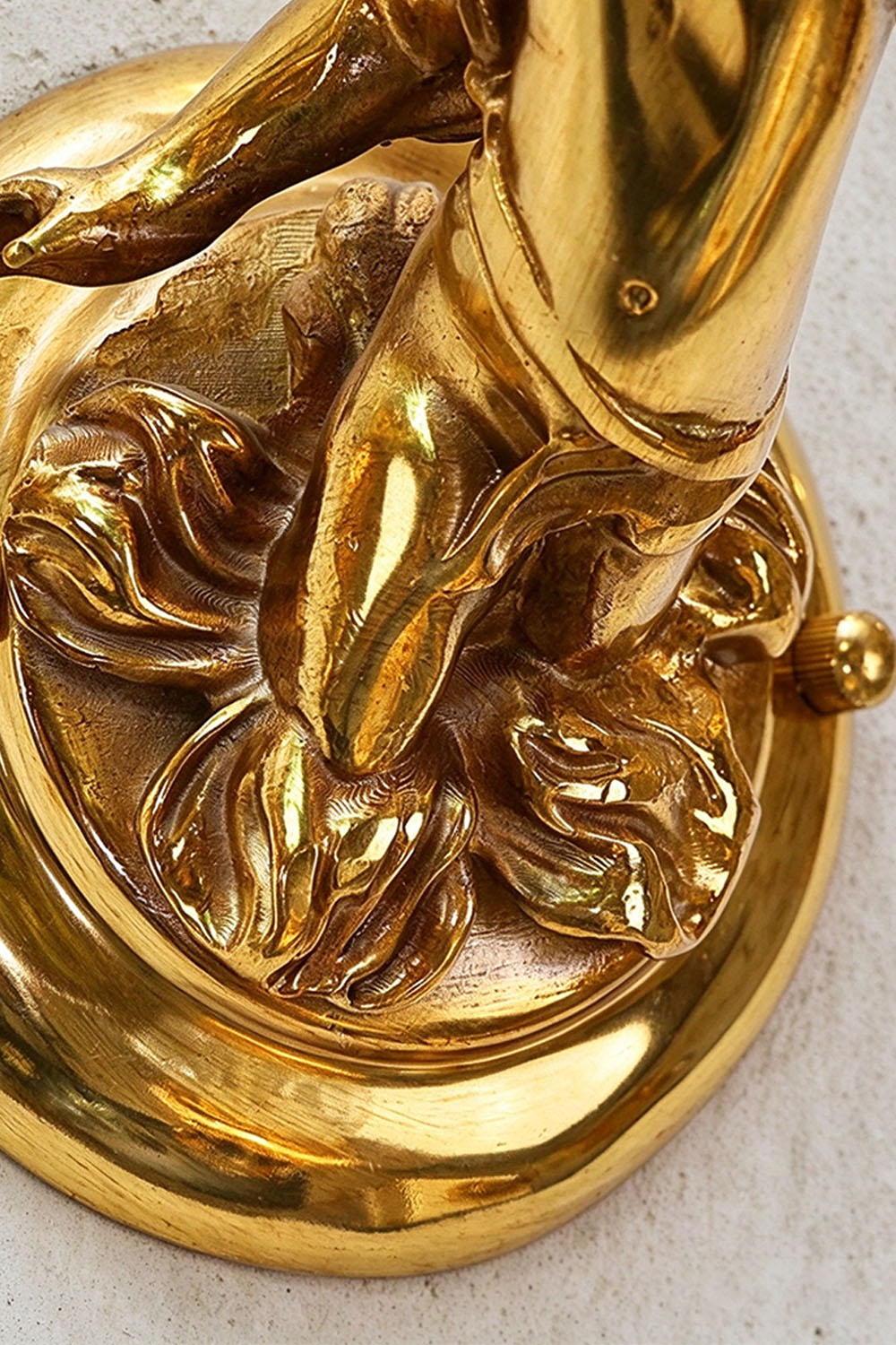 Ambrelise Cherub Wall Sconce | Polished Cast Brass | Detailed close-up of cherub feet and baroque backplate | Samu Lamp