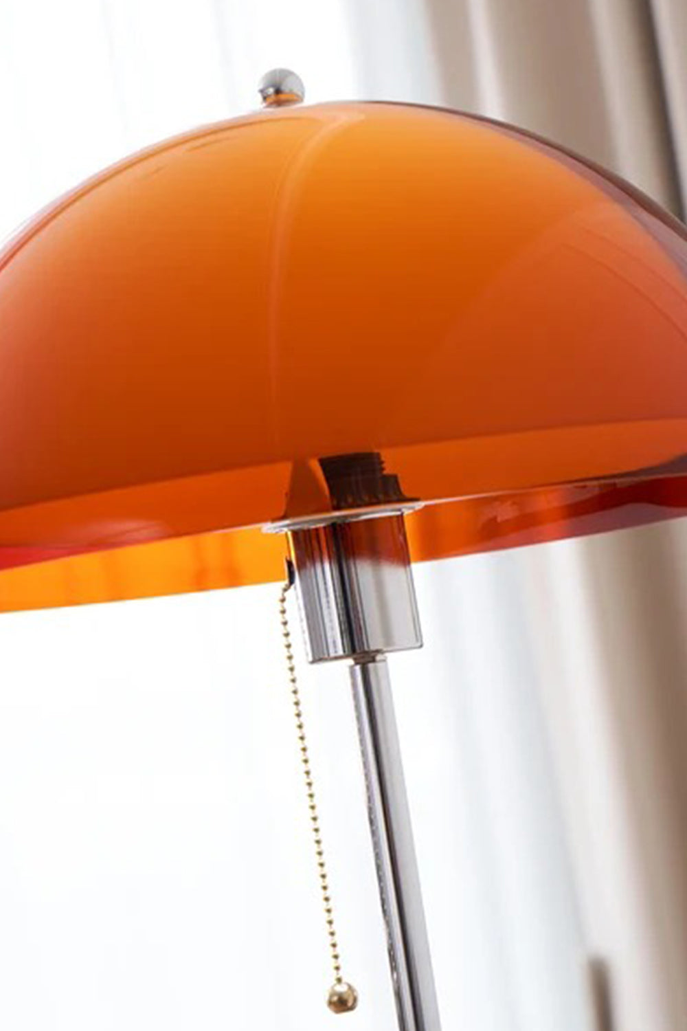 Ambrose Amber Dome Floor Lamp | Amber Glass, Metal and Wood | Close-up view of the illuminated orange-amber shade and pull chain switch | Samu Lamp
