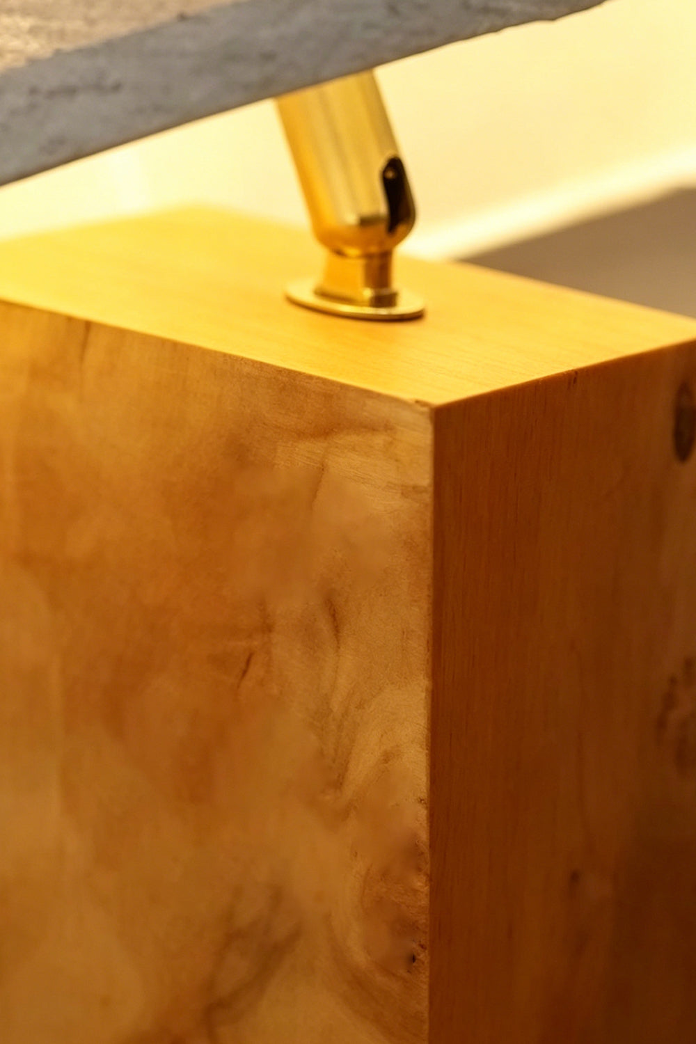 Angolo Canted Faceted Wood Table Lamp | Wood, Fabric, Metal | Close-up focus on the gold metal joint connector and the rich grain texture of the wood block base | Detail shot | Samu Lamp