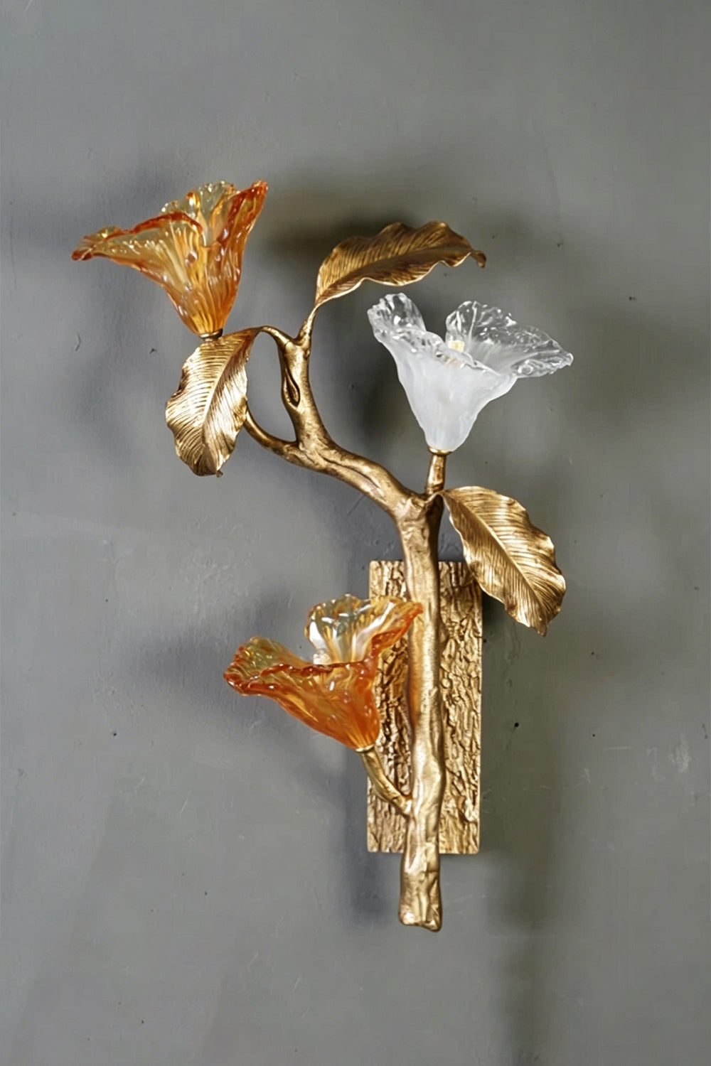 Arboreal Bloom Brass Wall Lamp | Brass, Glass | Frontal view of the unlit lamp against a grey textured wall | Isolated shot | Samu Lamp