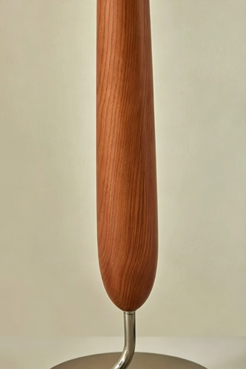Arden Walnut Floor Lamp | Wood, Metal, Fabric | Detailed close-up focus on the sculpted teardrop-shaped central body highlighting the natural rich brown walnut wood grain texture | Detail shot | Samu Lamp