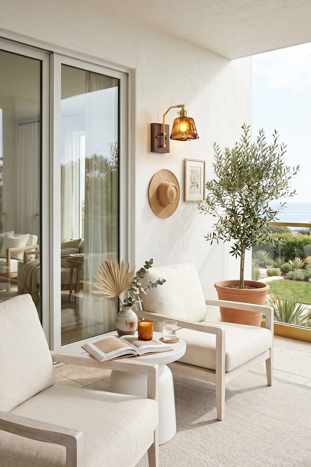 Arlo Amber Ripple Wall Lamp | Glass, Metal, Wood | Mounted on a white wall as exterior accent lighting on a contemporary balcony with white lounge chairs next to sliding glass doors | Samu Lamp