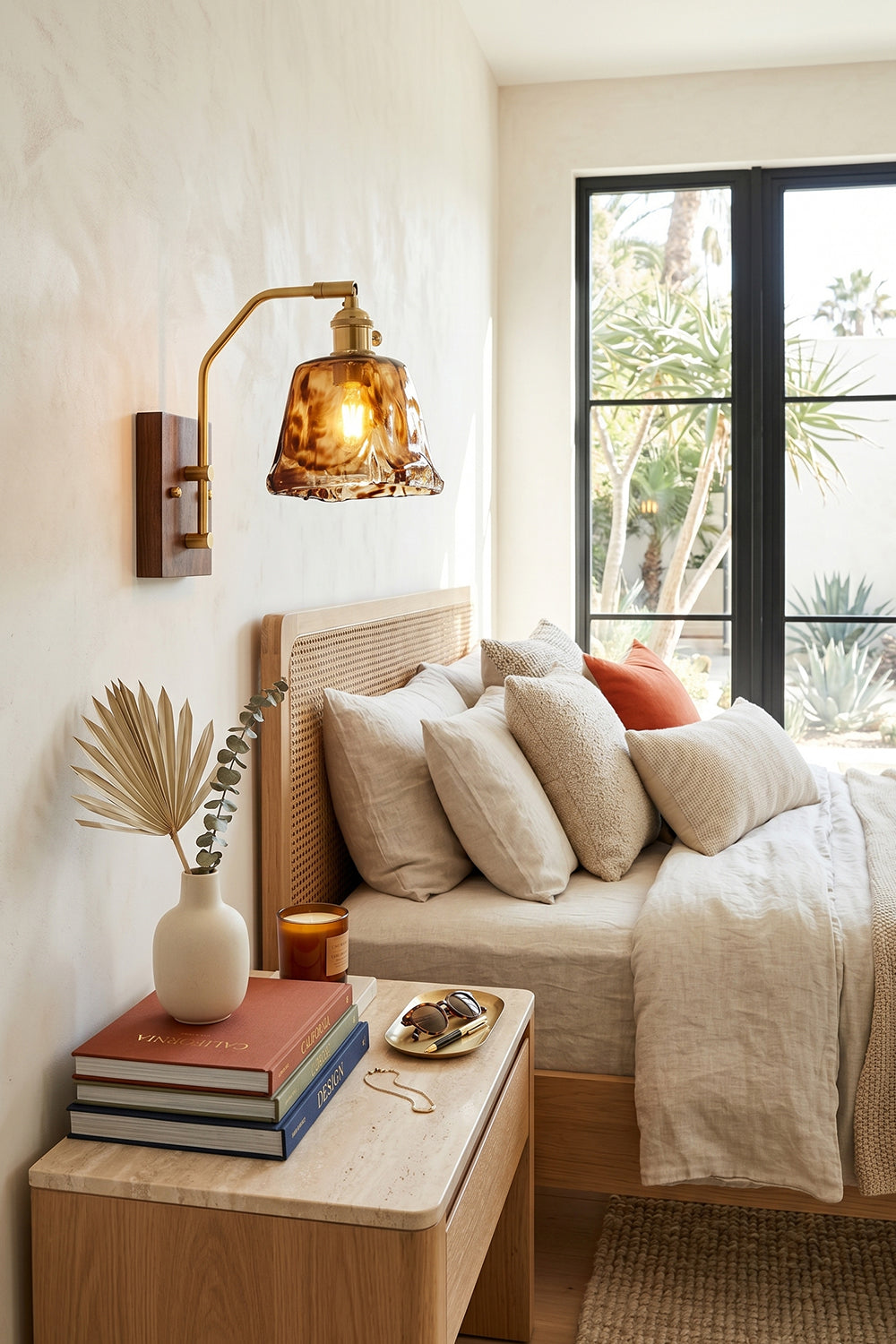 Arlo Amber Ripple Wall Lamp | Glass, Metal, Wood | Mounted above a light wood nightstand, casting cozy illumination over a classical bed setup with plush pillows | Samu Lamp