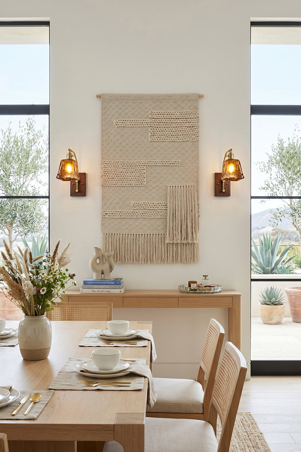 Arlo Amber Ripple Wall Lamp | Glass, Metal, Wood | Flanking a bohemian woven wall hanging above a wooden console table in a bright minimalist dining room | Samu Lamp