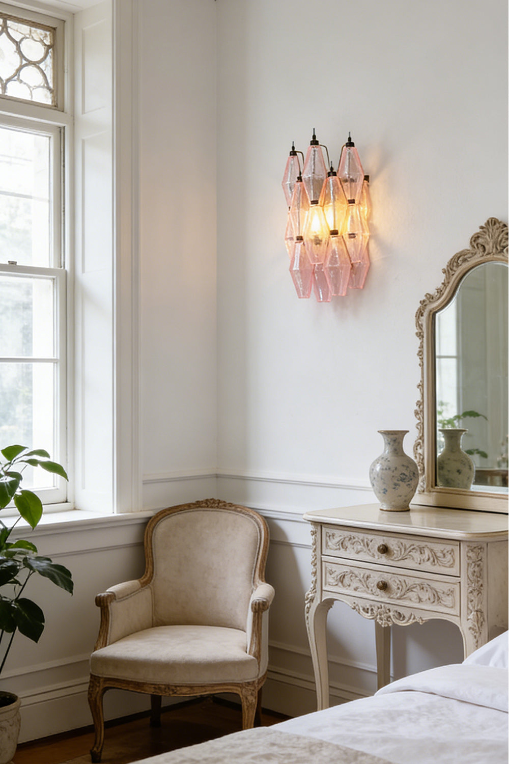 Lit pink polyhedral glass wall lamp | Metal, Glass | Bedroom interior scene next to a window | Samu Lamp