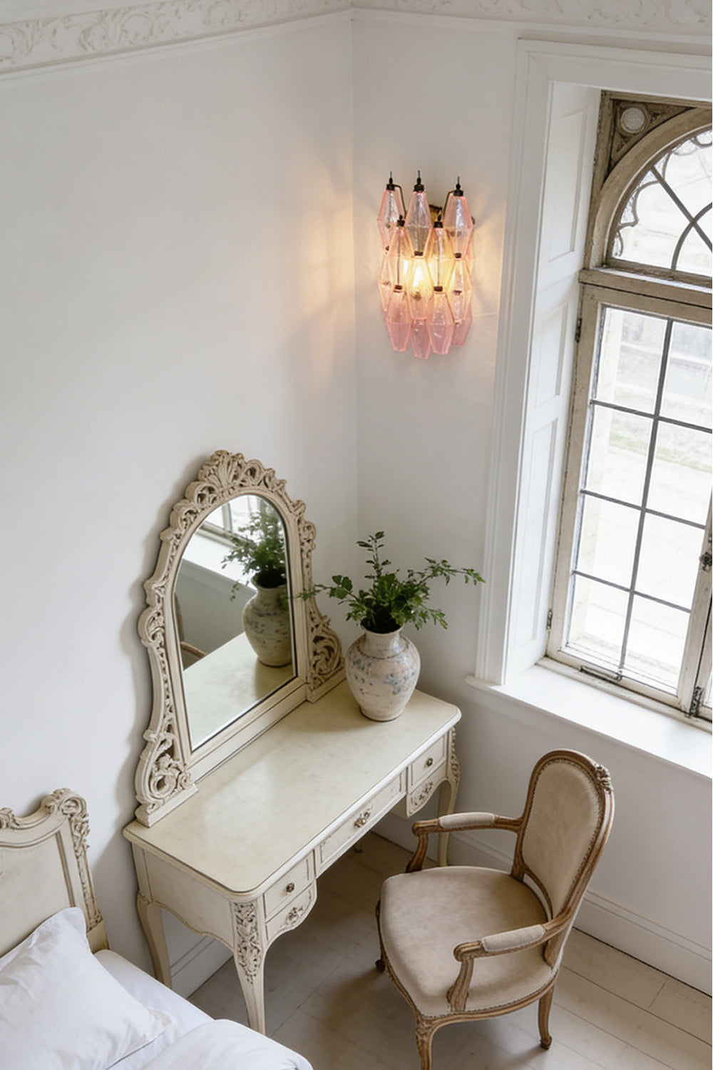 Lit pink glass wall sconce | Metal, Glass | Mounted in a classic dressing room above a desk | Samu Lamp