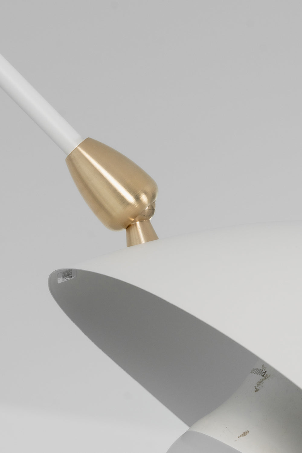 Brass articulation hardware on white metal arm | Metal | Macro shot showing the high-quality joint connection | Samu Lamp