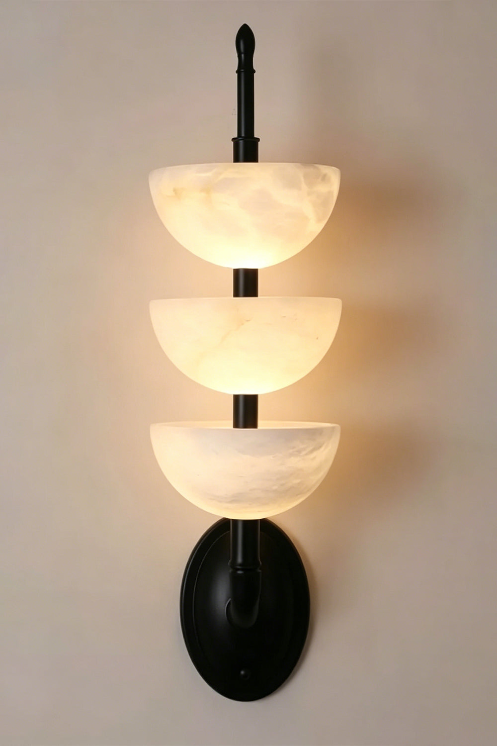 Ascendant Wall Lamp with black finish | Alabaster, Metal | Lit view with matte black mounting hardware | Samu Lamp