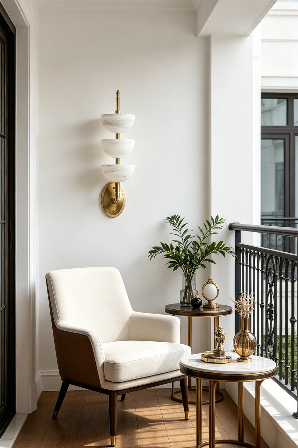 Ascendant Wall Lamp on balcony | Alabaster, Brass | Sunlit white wall next to comfortable armchair | Samu Lamp