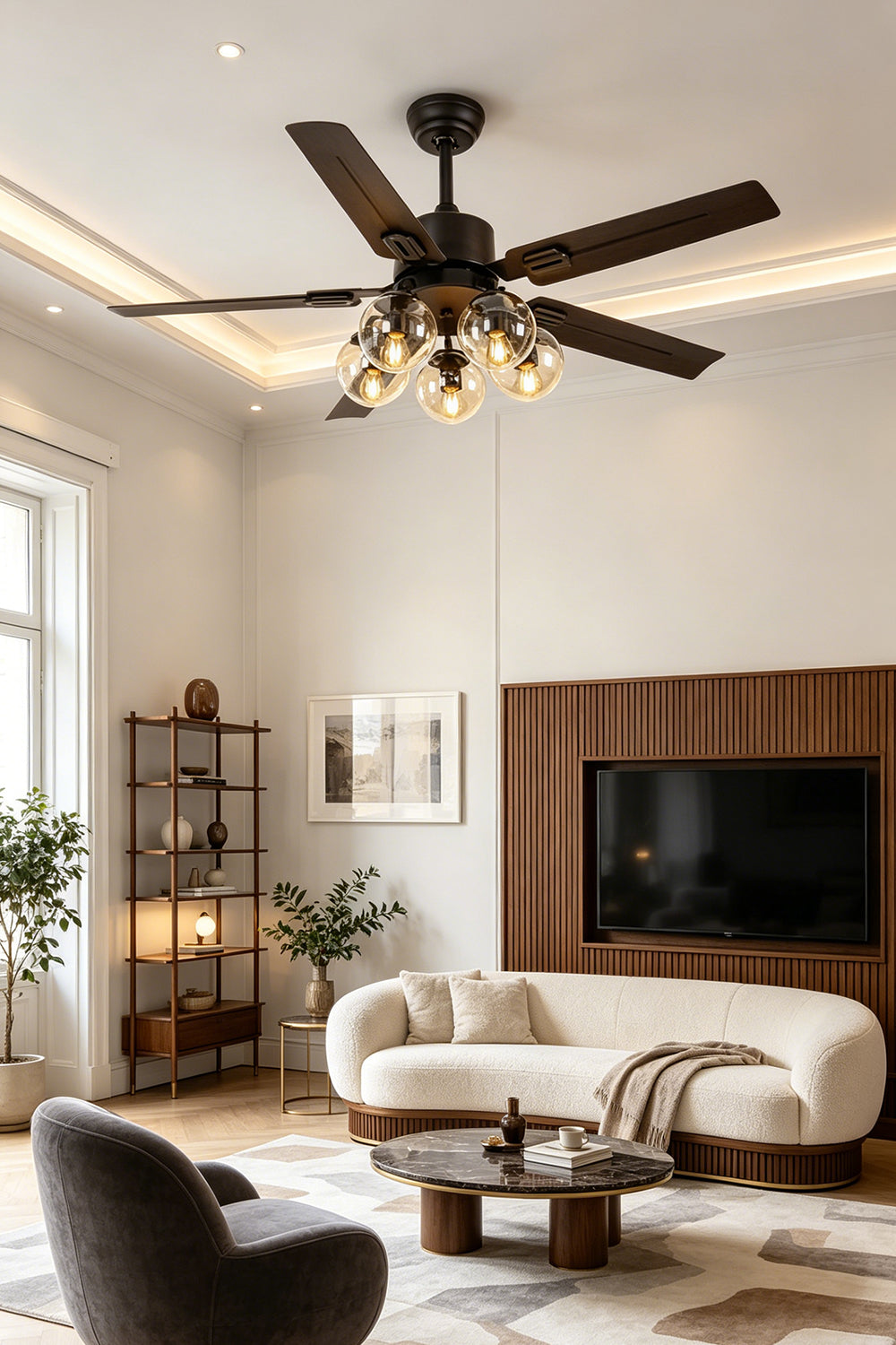 Astraea Modern Glass Globe Ceiling Fan Light | Glass, Metal, Wood | Installed as a functional overhead lighting piece in a stylish contemporary living room with a cream curved sofa and rich wood paneling | Samu Lamp