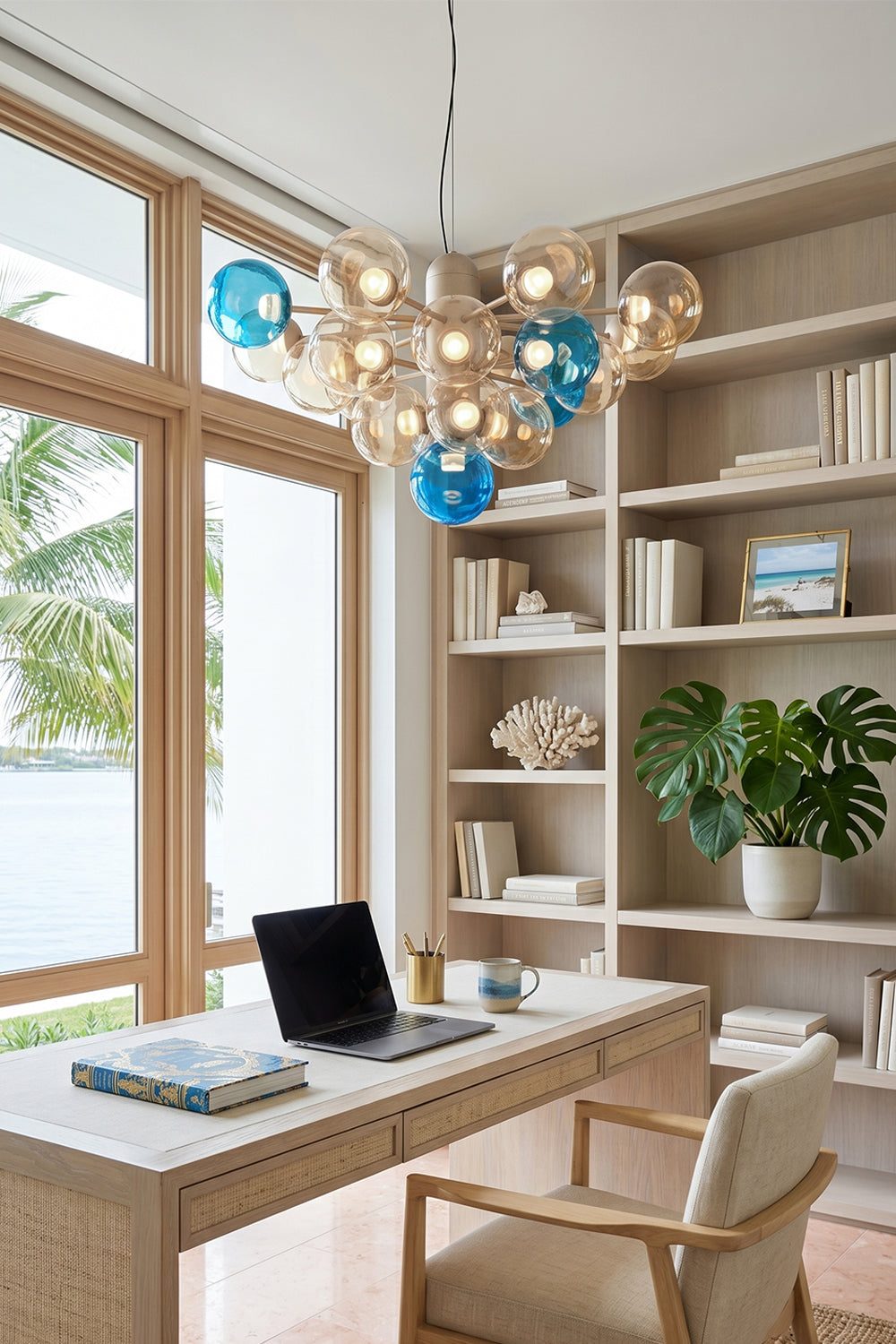 Astraea Prismatic Globe Chandelier | Glass, Metal | Placed as a statement light fixture in a modern home office with a minimalist desk and built-in library bookshelves | Samu Lamp