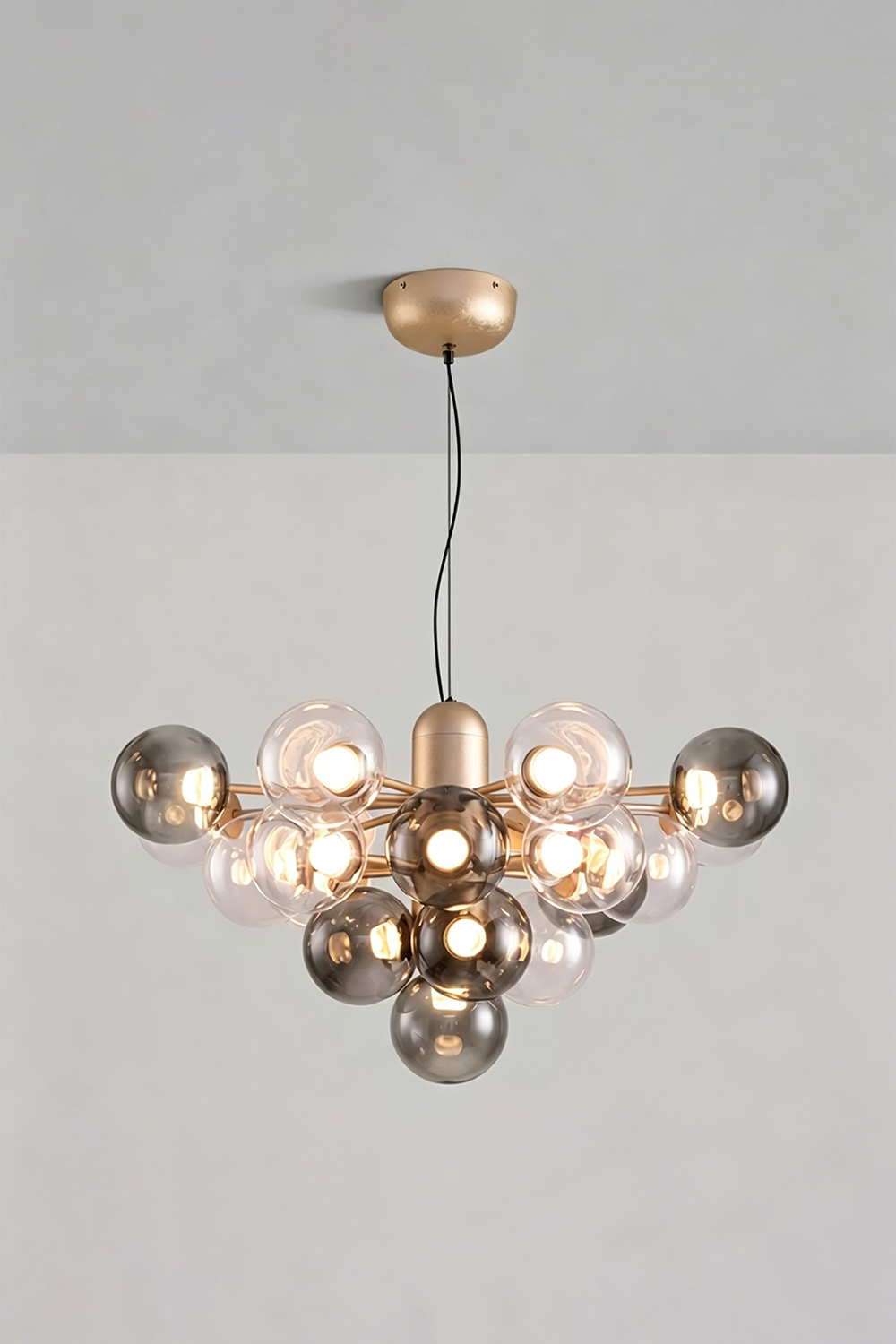 Astraea Prismatic Globe Chandelier | Glass, Metal | Studio view of the smoky mirror grey glass bubble variant fully illuminated against a plain grey backdrop | Samu Lamp