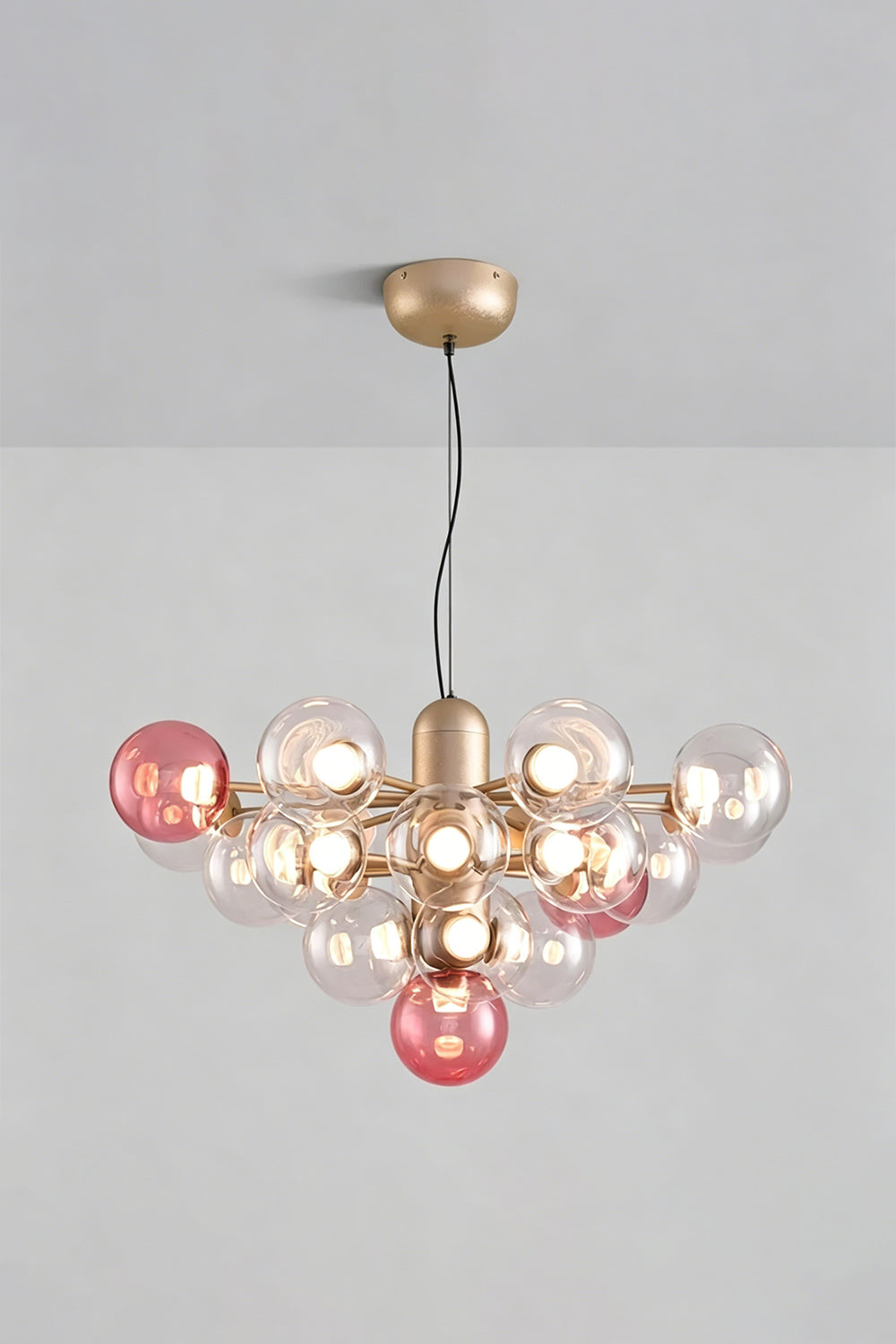 Astraea Prismatic Globe Chandelier | Glass, Metal | Studio view of the romantic rose pink glass bubble variant fully lit against a plain grey background | Samu Lamp