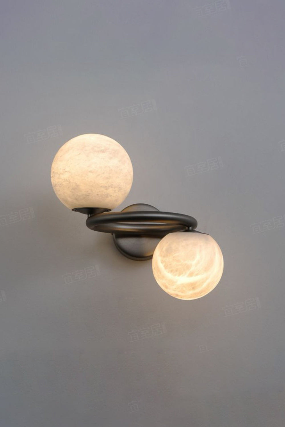 Aura Two-Globe Alabaster Wall Sconce with hand-shaped alabaster globes and curved metal arm.