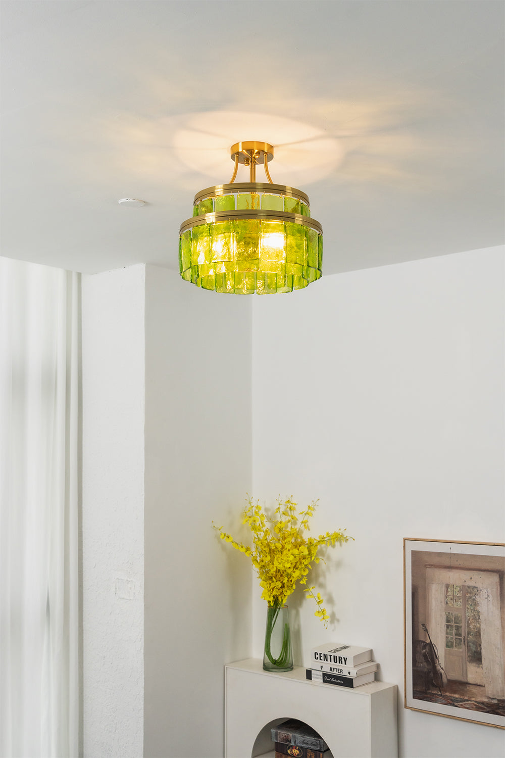 Aura Verdant Tiered Green Glass Ceiling Light | Metal, Glass | Mounted on the ceiling of a minimalist room corner above a white sideboard with yellow flowers | Samu Lamp