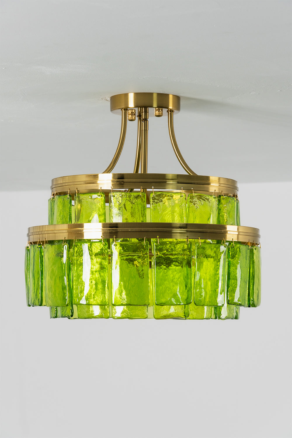 Aura Verdant Tiered Green Glass Ceiling Light | Metal, Glass | Frontal view of the unlit green glass tiered ceiling light against a neutral grey studio background | Isolated shot | Samu Lamp