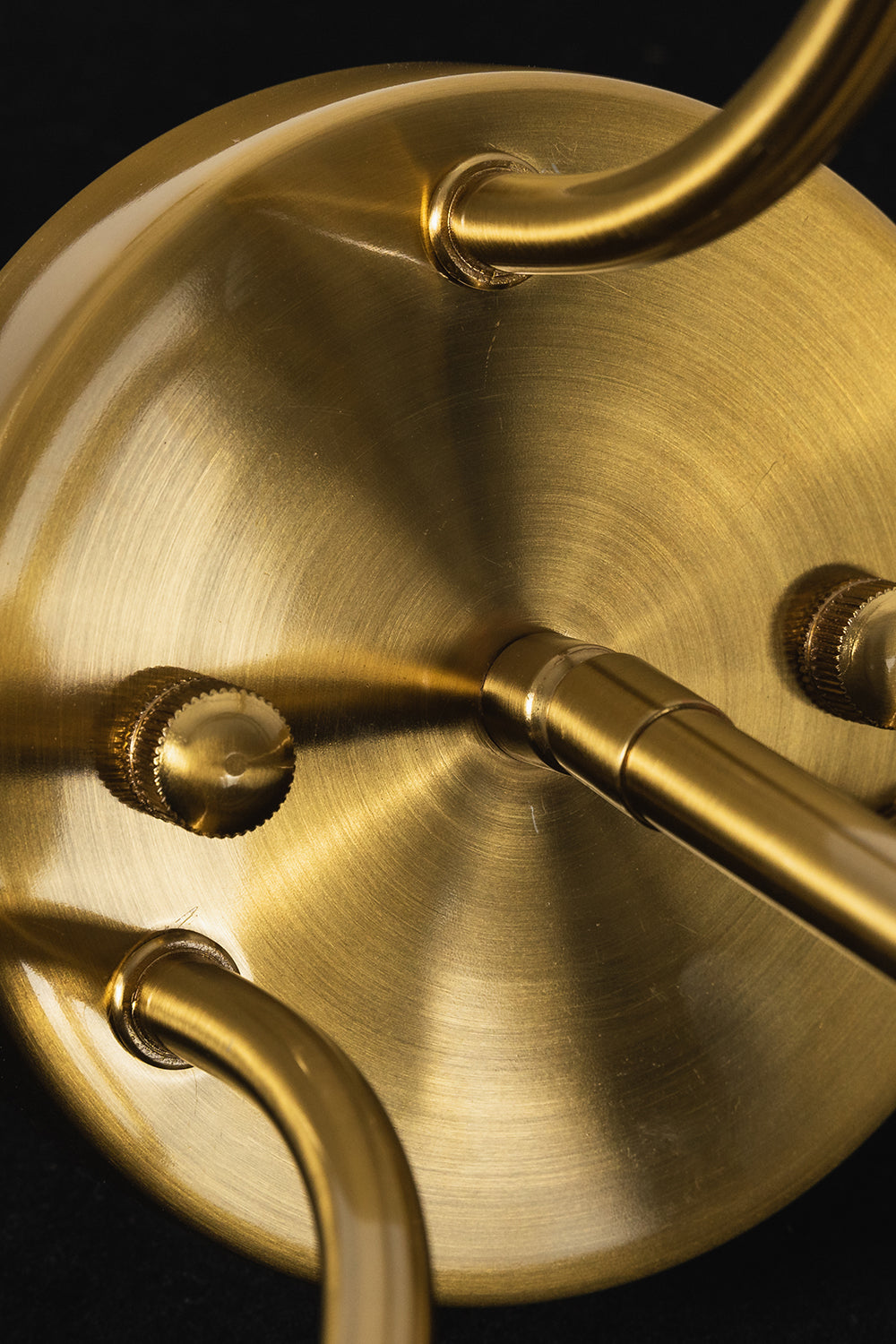 Aura Verdant Tiered Green Glass Ceiling Light | Metal, Glass | Macro focus on the brushed brass ceiling canopy and the curving metal support arms | Detail shot | Samu Lamp