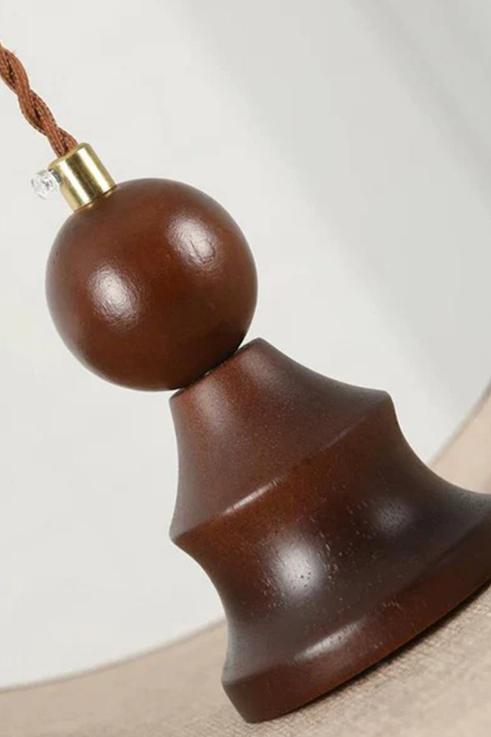 Aurelia Blossom Glass Pendant Light | Wood, Fabric, Glass | Close-up view of the decorative dark turned wood bead finial and brass hardware connecting the shade to the braided cord | Detail shot | Samu Lamp