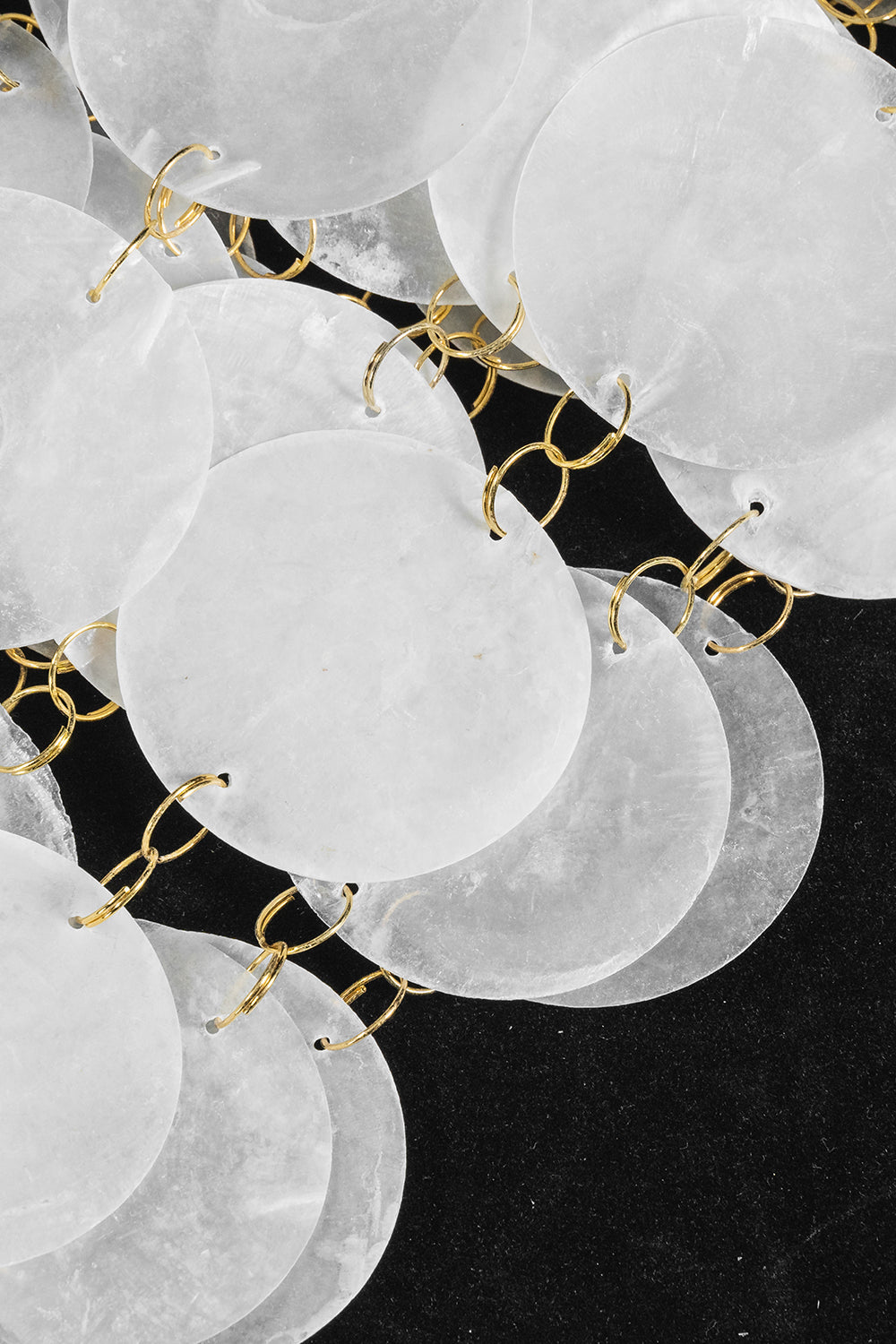 Aurelia Tiered Capiz Table Lamp | Capiz Shell, Metal | Macro close-up under studio lighting highlighting the overlapping natural texture of the white capiz shells | Detail shot | Samu Lamp